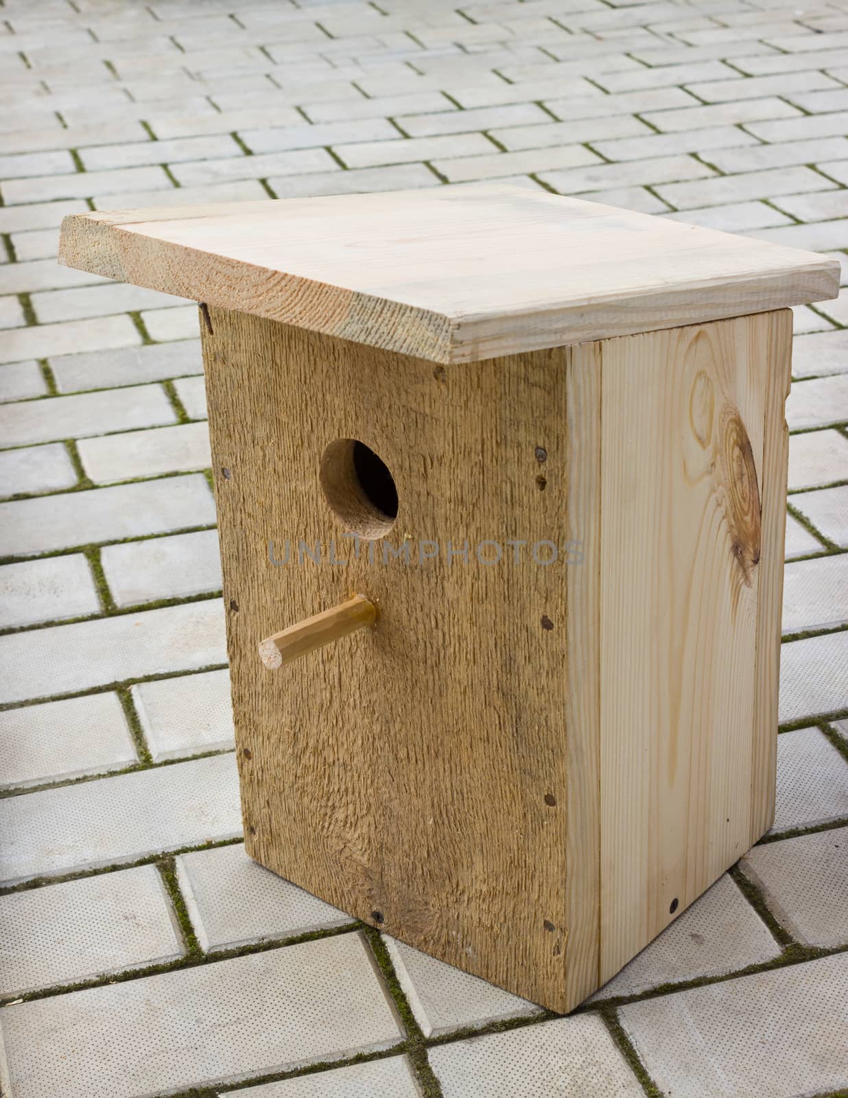 Small birdhouse from wooden planks on the floor