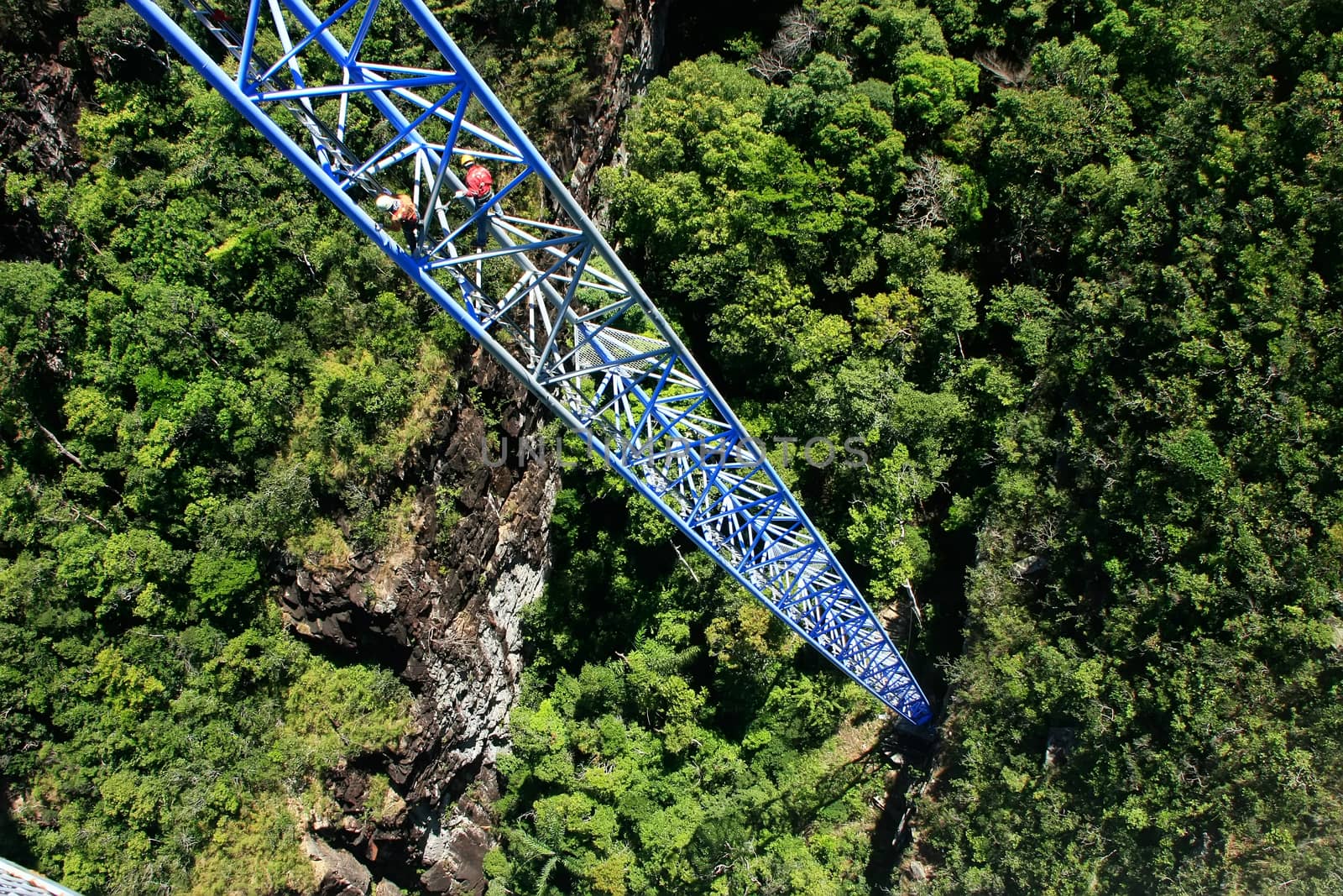 Workers climing supporting pole, Sky Bridge, Langkawi island, Malaysia