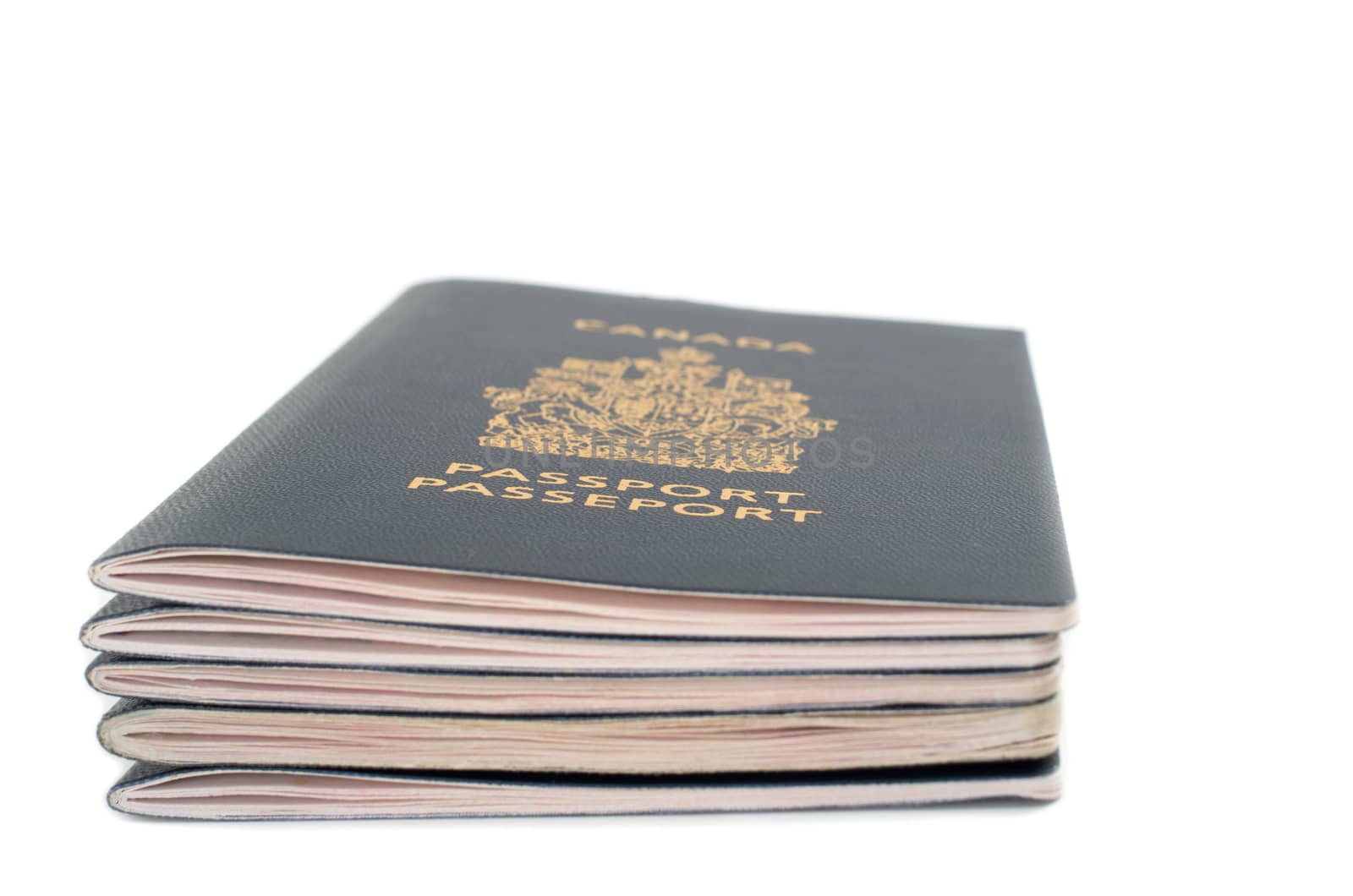 Pile of five passports viewed from the side on white background by daoleduc