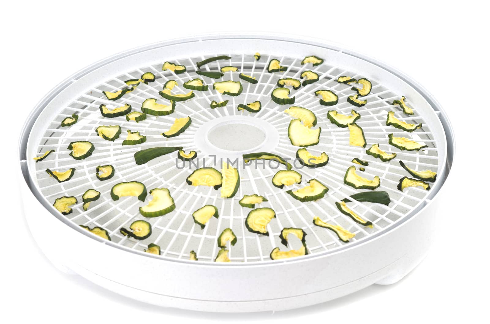 Dehydrated cucumber slices on food dehydrator tray