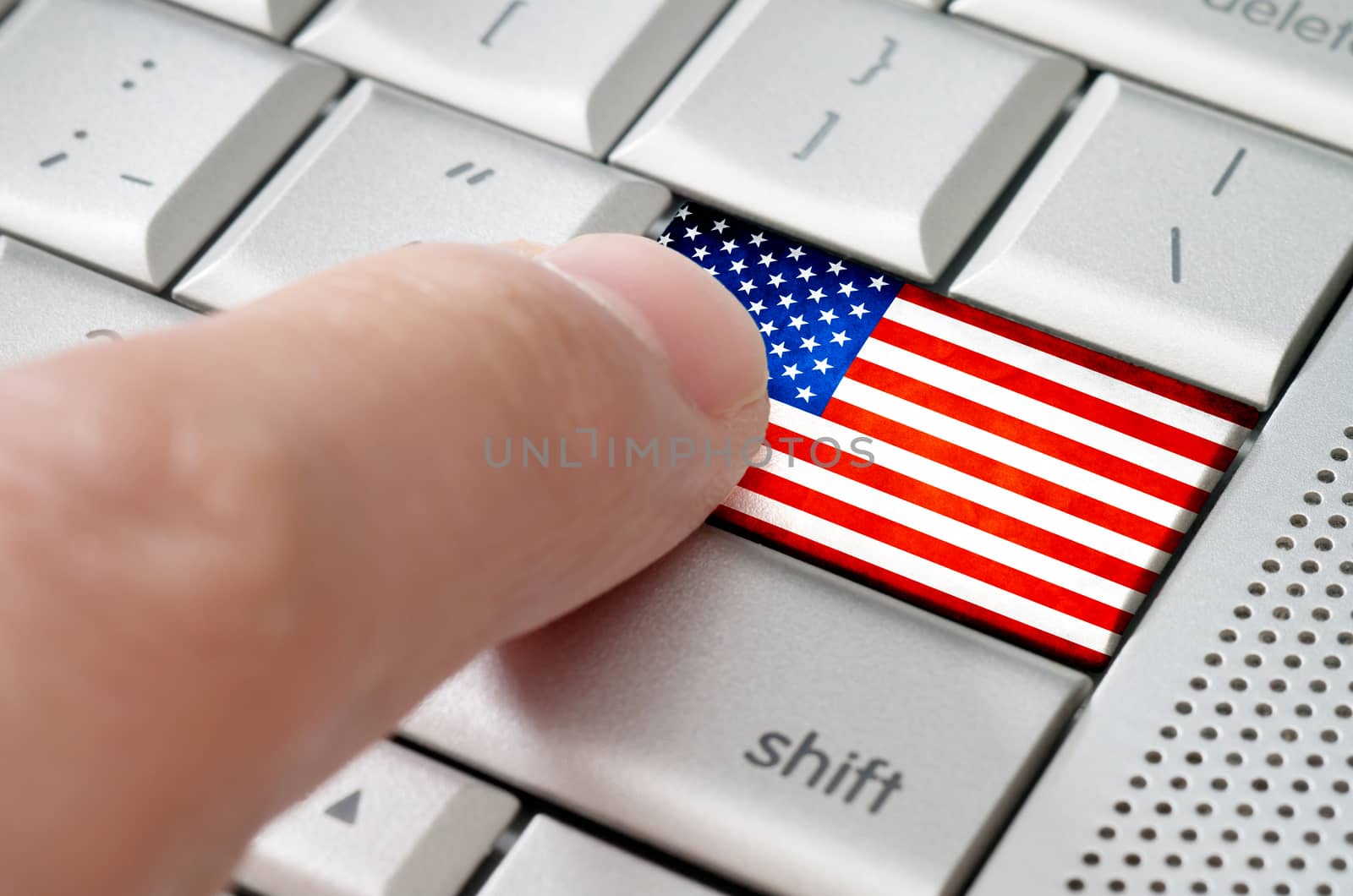 Business concept male finger pressing American enter key on metallic keyboard