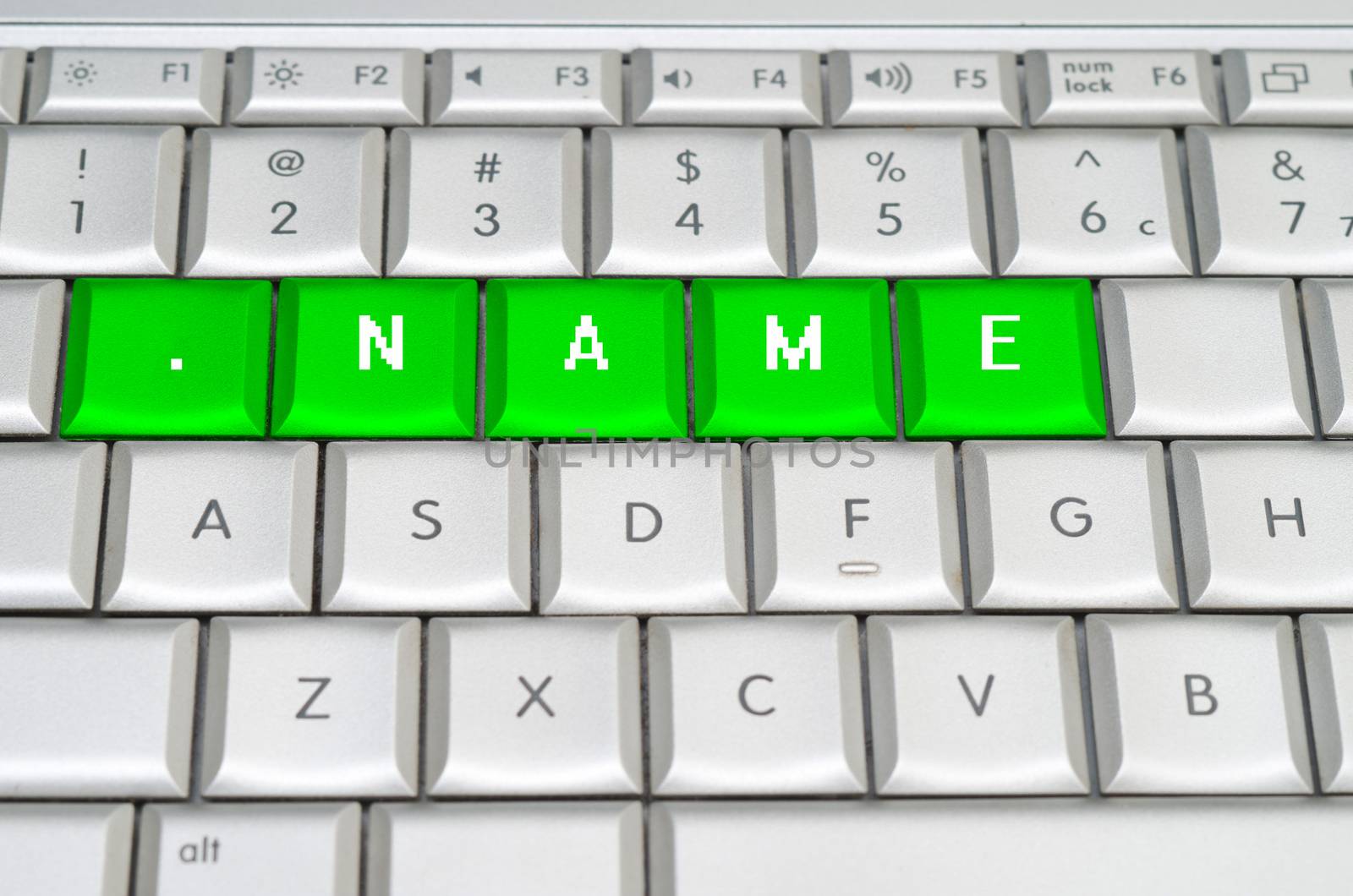 Internet top level domain .name spelled on metallic keyboard