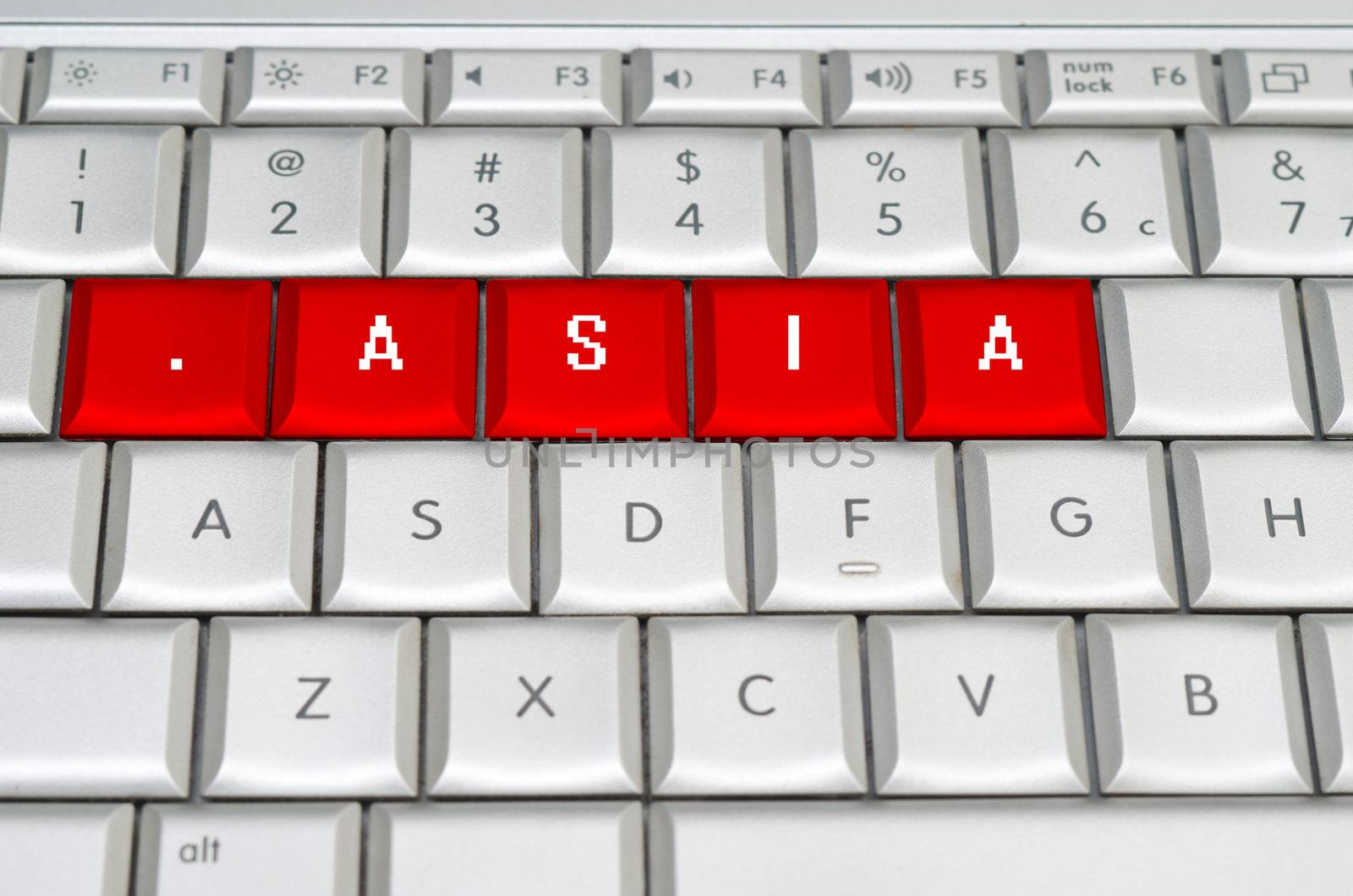 Internet top level domain .asia spelled on metallic keyboard