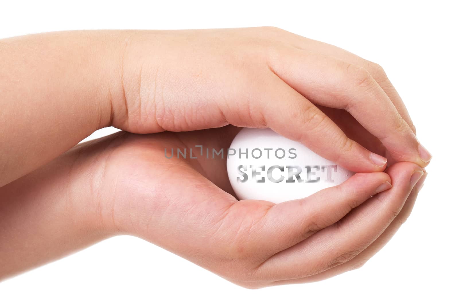 Secrecy concept with two asian child hands protecting an egg with secret word fading on it