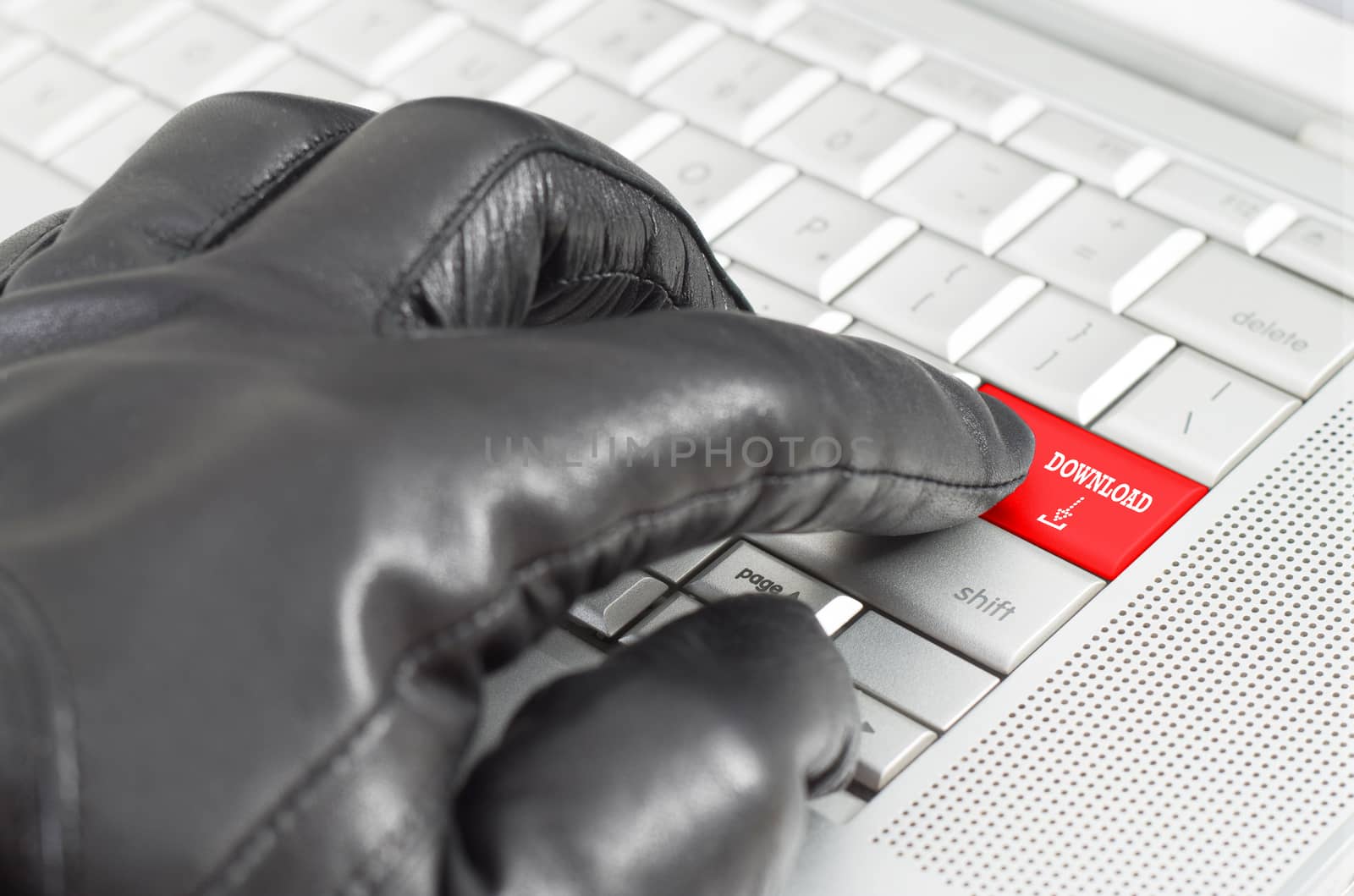 Online illegal download with hand wearing black leather glove pressing enter key