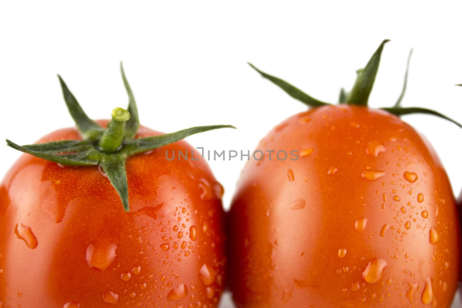 Fresh red tomato with green stem on white background