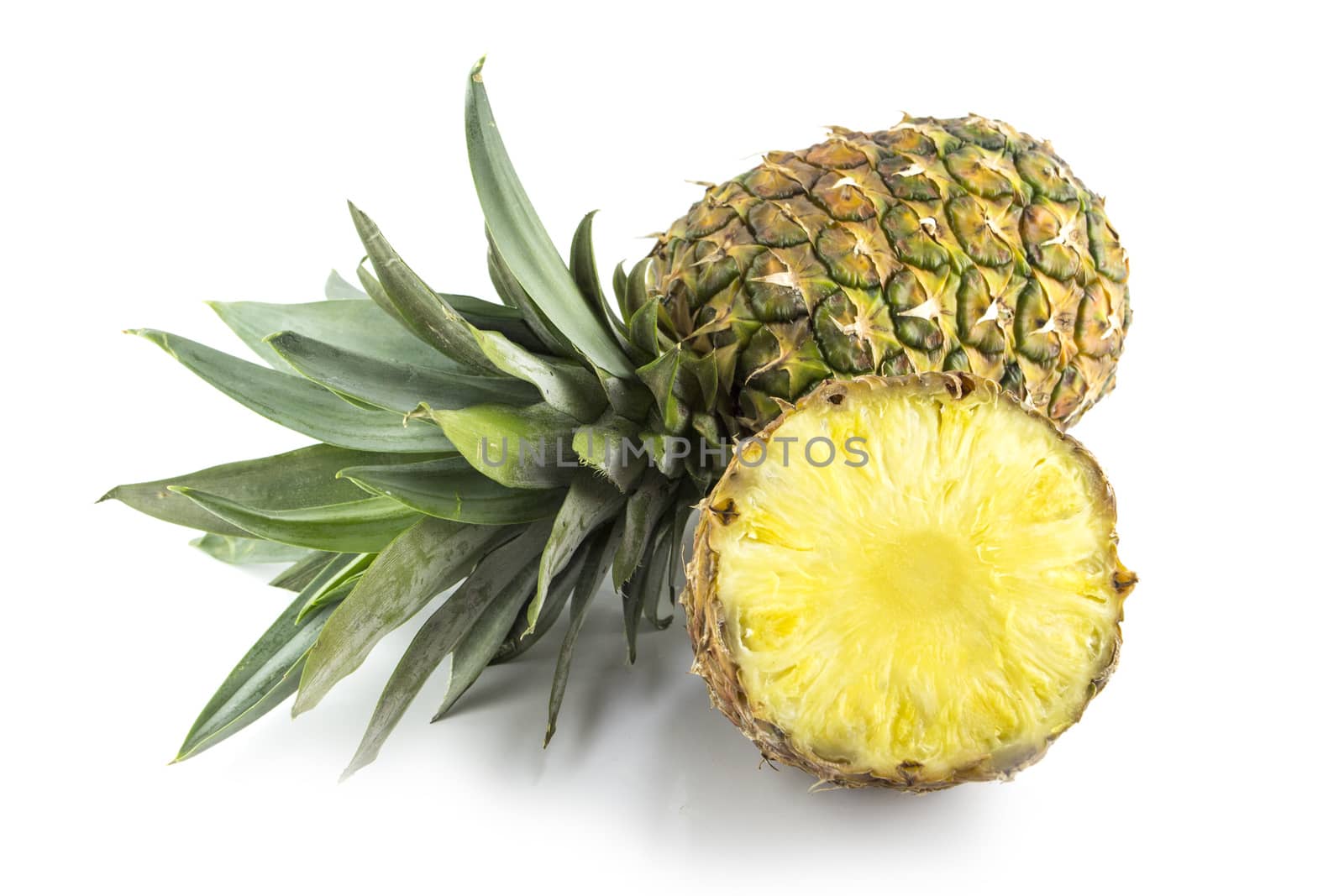 Ripe pineapple with slices isolated on white background