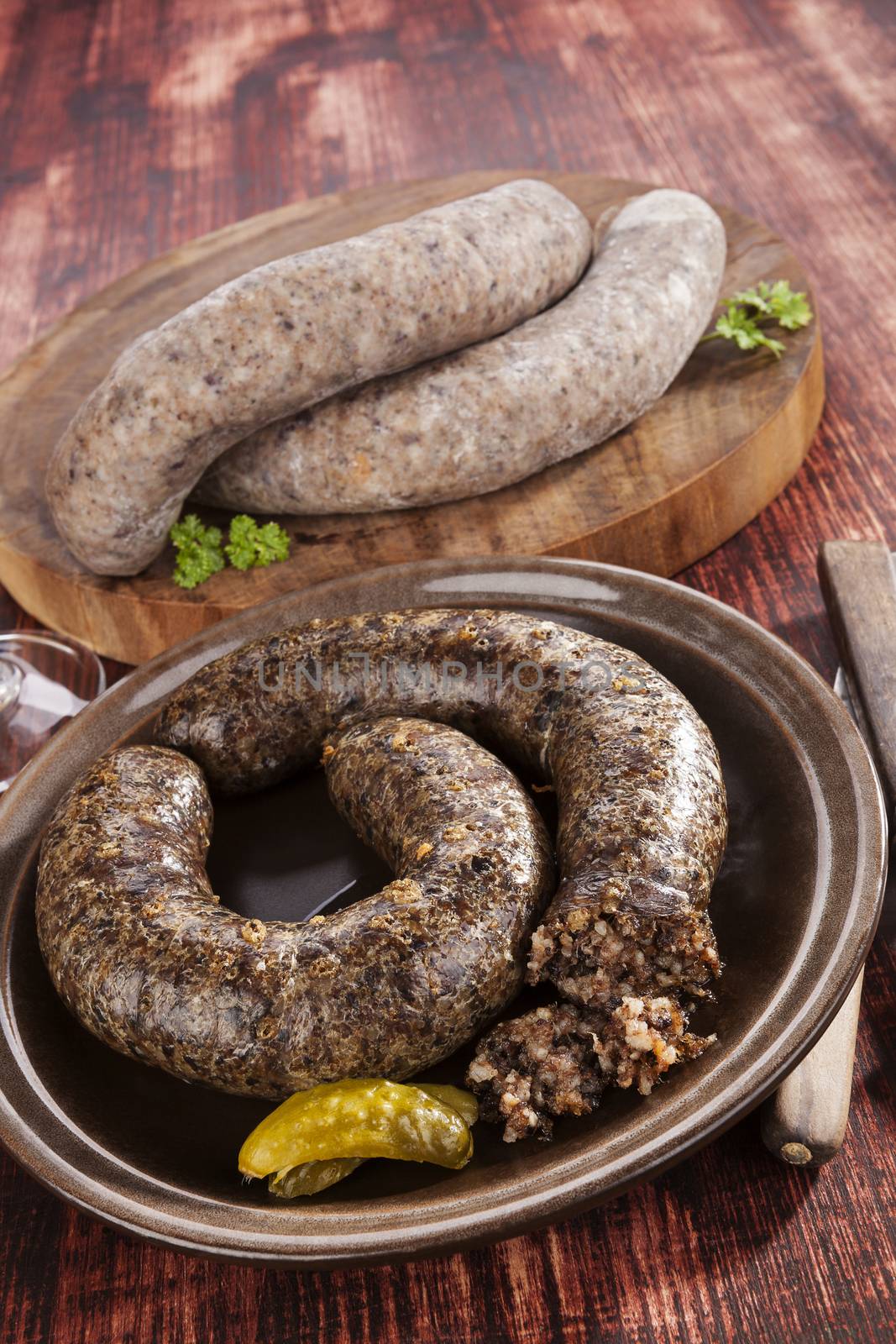 Blood sausage and rice sausage on wooden background. Culinary traditional european eating, rustic style.