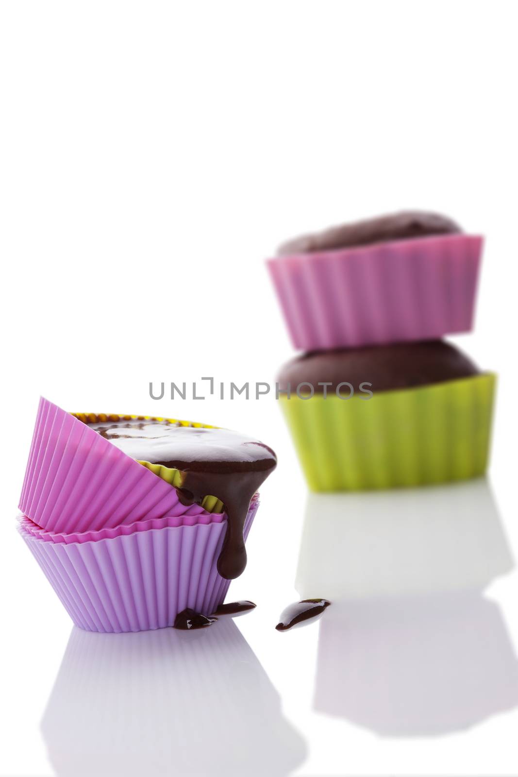 Making cupcakes. Cupcake mixture in neon colored silicone baking forms isolated on white background. 