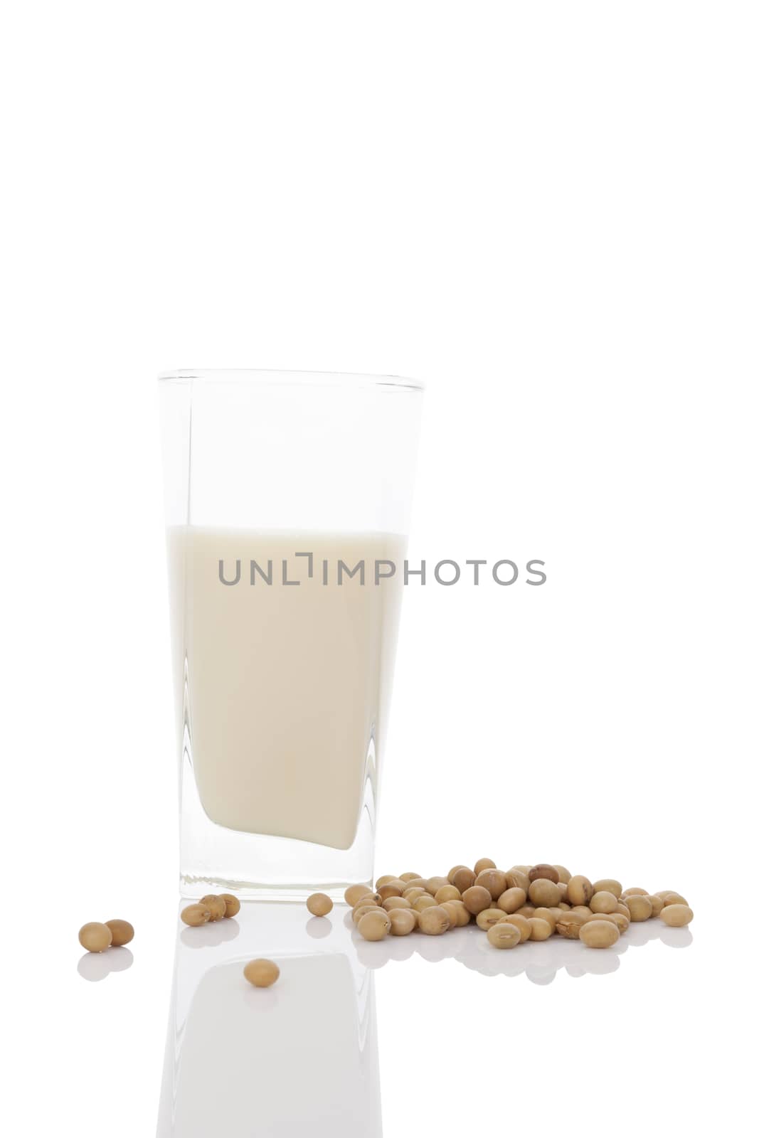 Glass of organic soya milk with soya beans  isolated on white background. Healthy vegan eating.