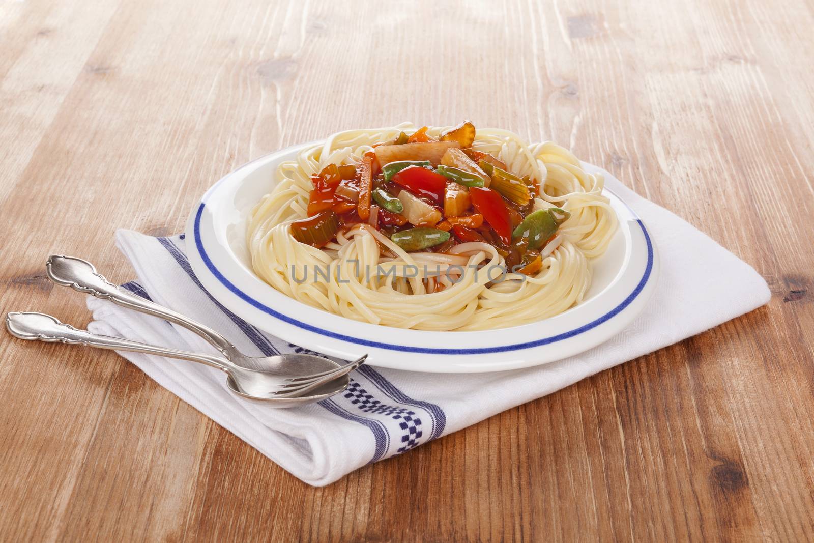 Spaghetti pasta with tomato sauce and steamed vegetables. Healthy pasta eating.