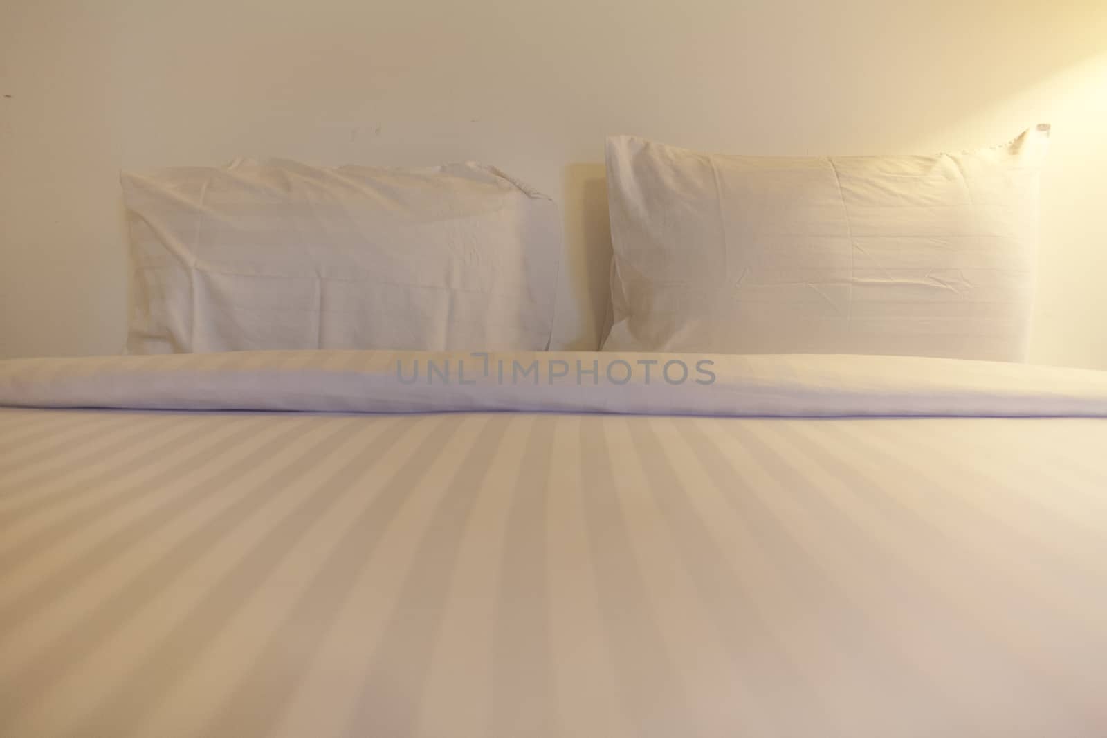 Twin white pillow on bed by 2nix