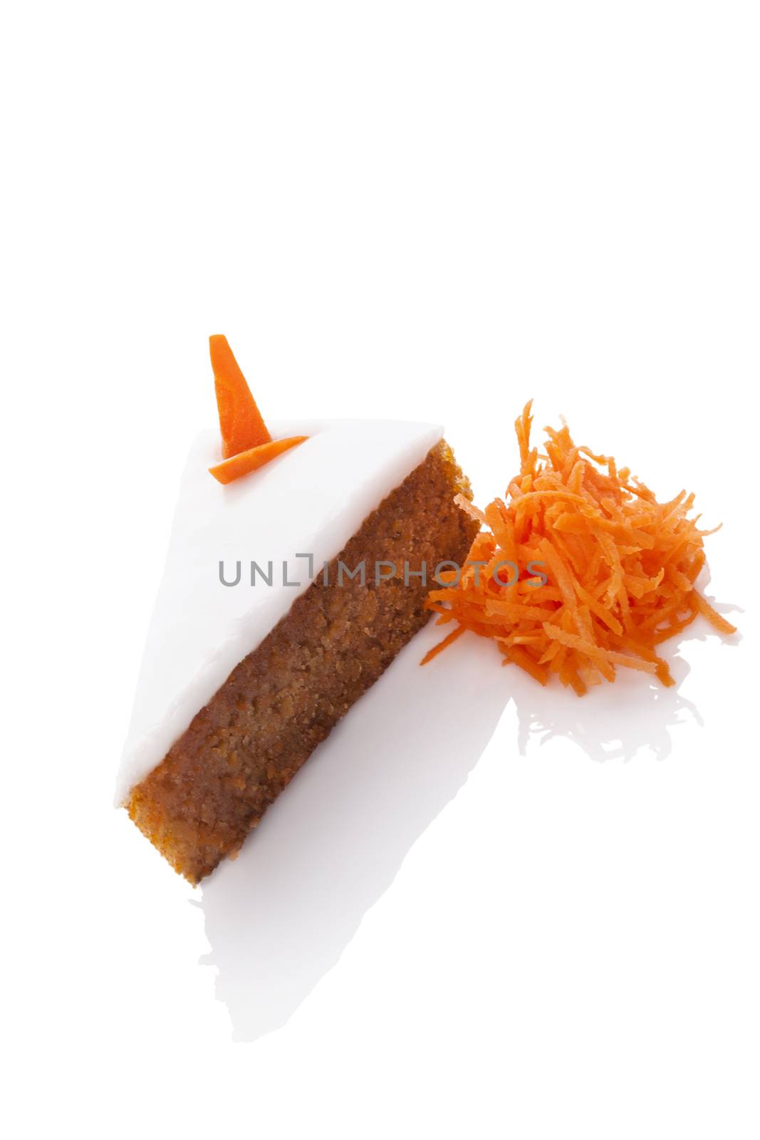 Delicious carrot cake on grated carrots isolated on white background. Culinary sweet dessert.