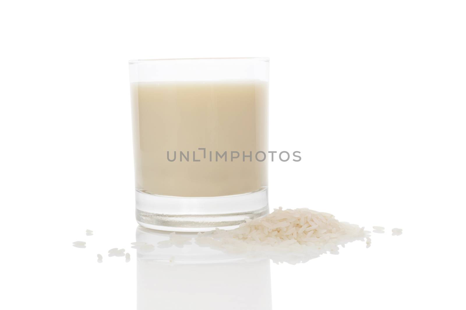 Rice milk in glass isolated on white background. Vegan and vegetarian milk concept.