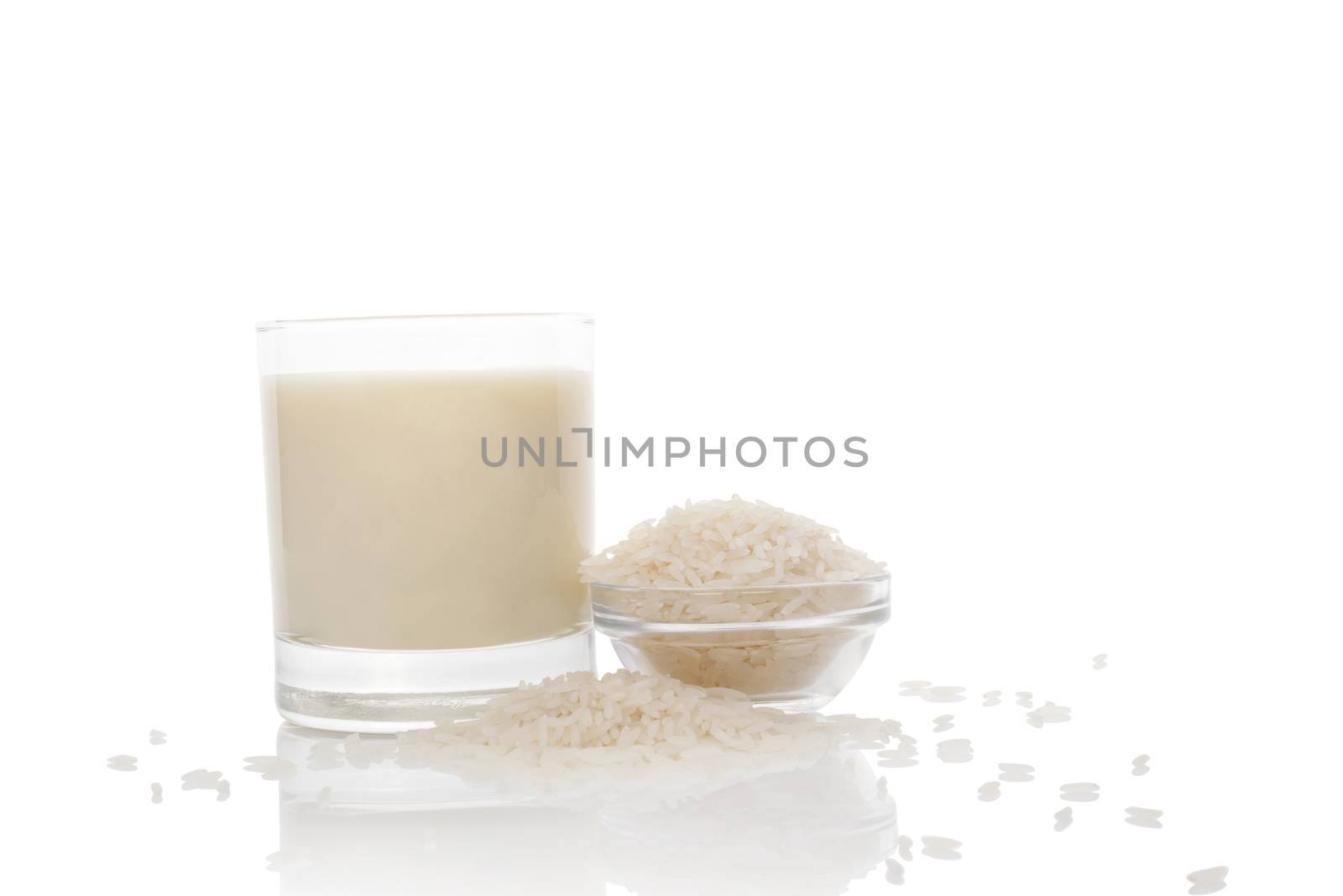 Rice milk in glass and rice crop  isolated on white background. Vegan and vegetarian milk concept.