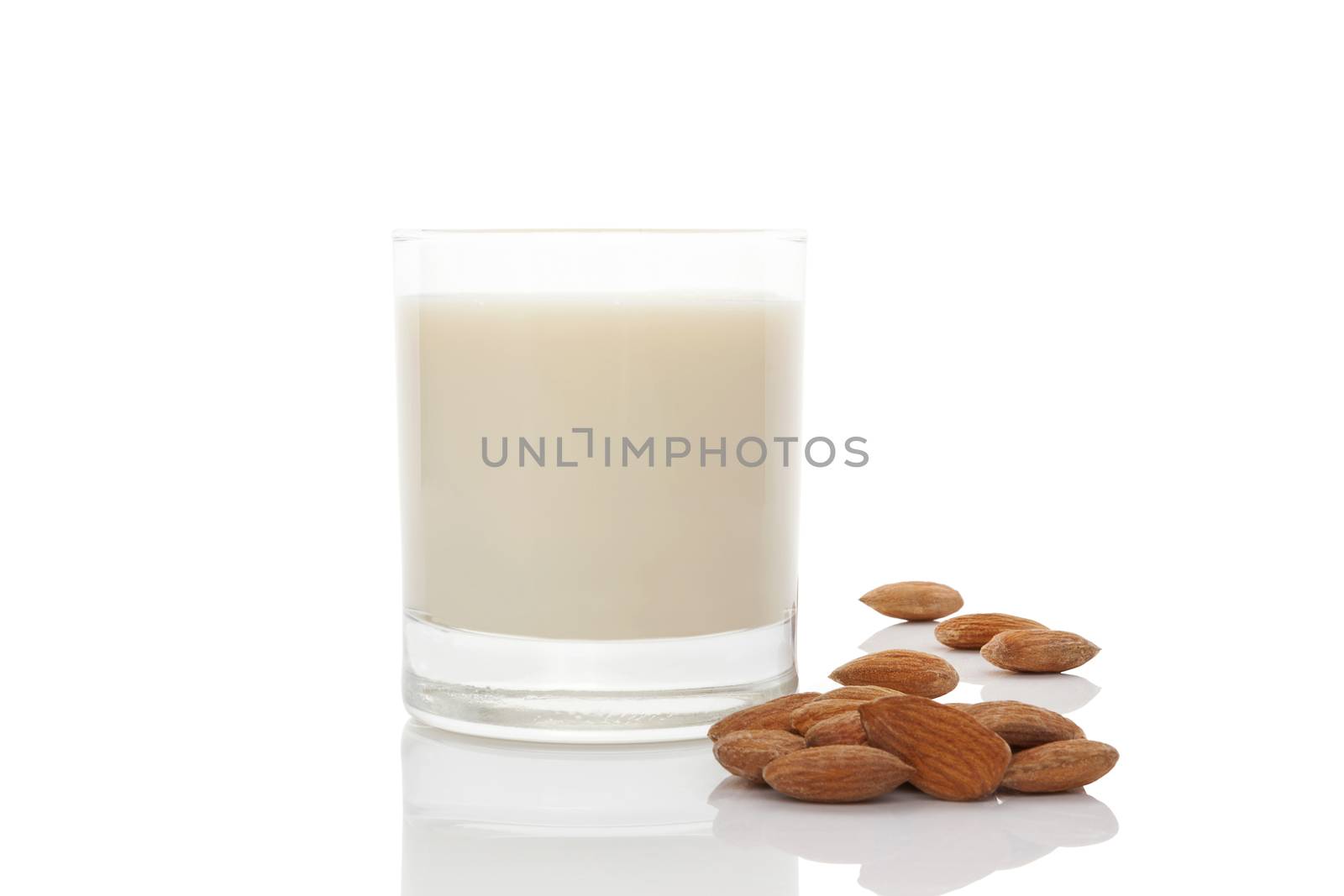 Almond milk in glass with almond nuts  isolated on white. Vegan and vegetarian eating.