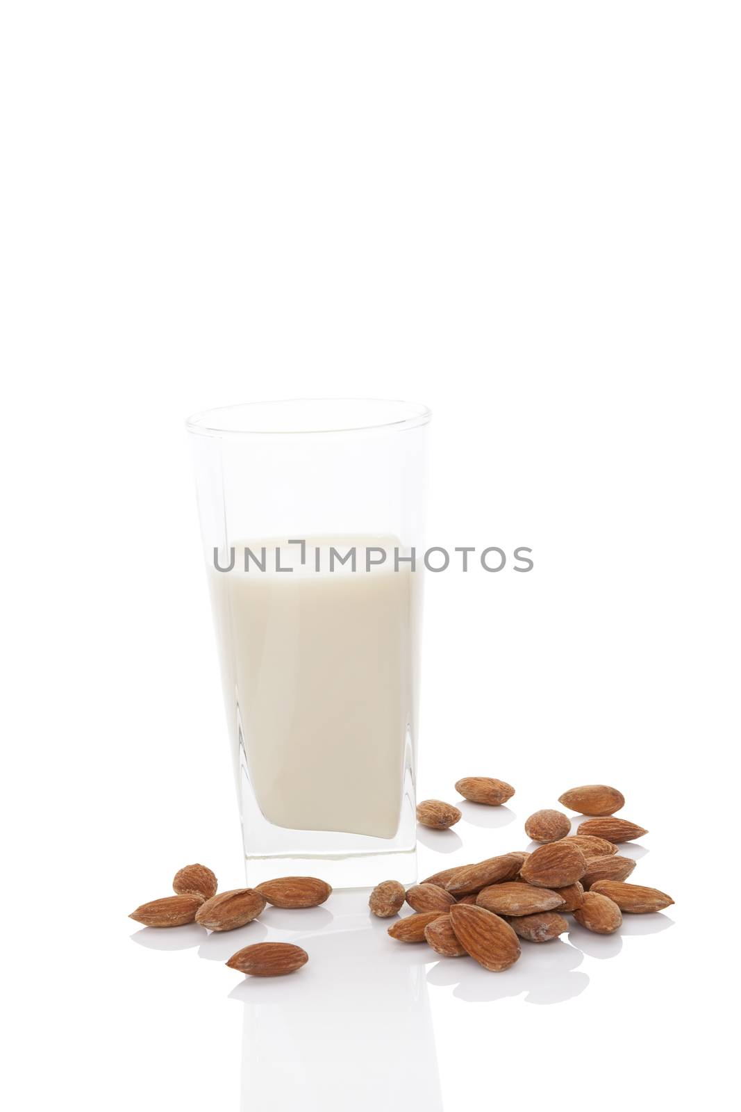 Almond milk in glass with almond nuts isolated on white background. Vegan and vegetarian milk concept.