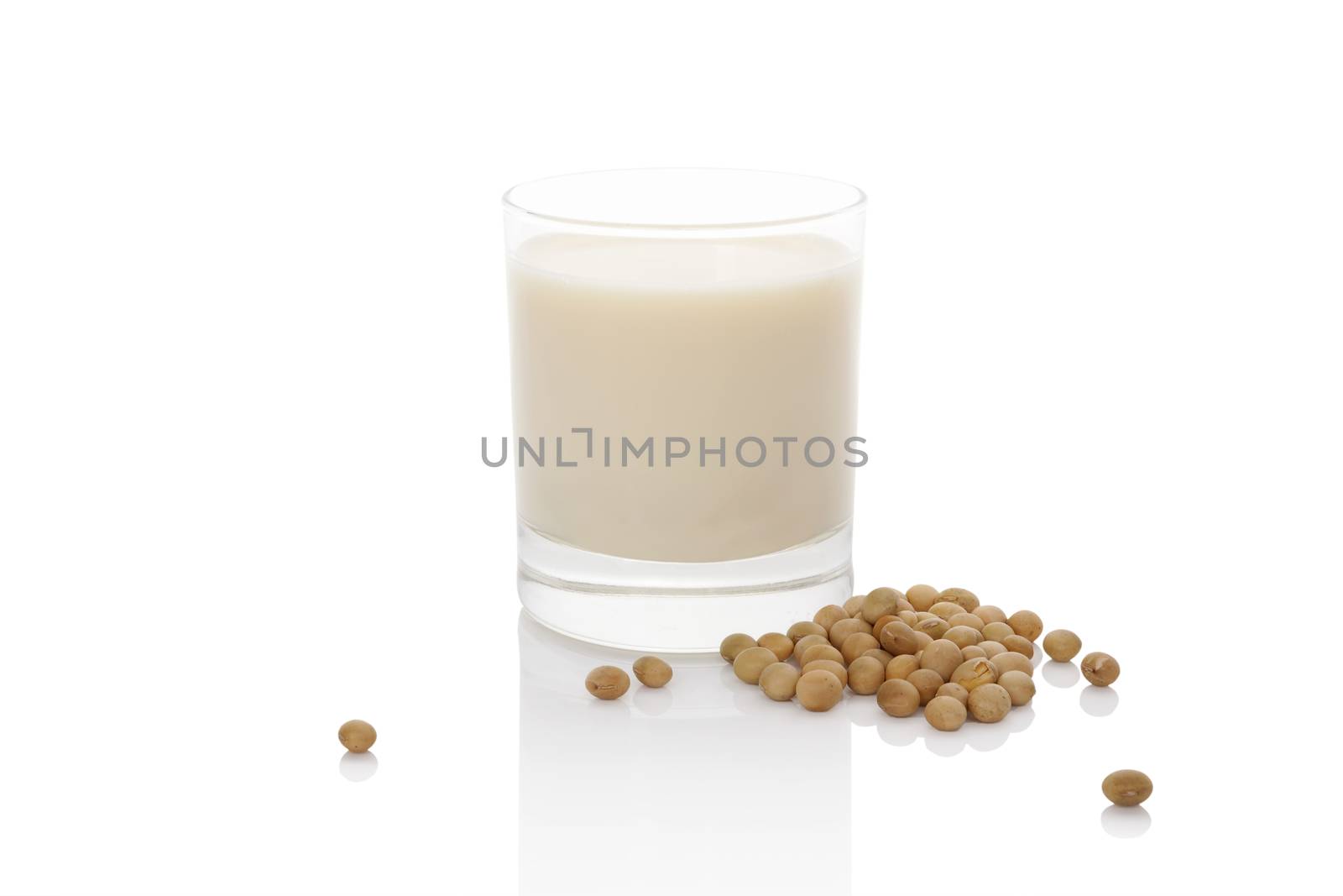 Soy milk in glass with soya beans isolated on white. Vegan milk concept.