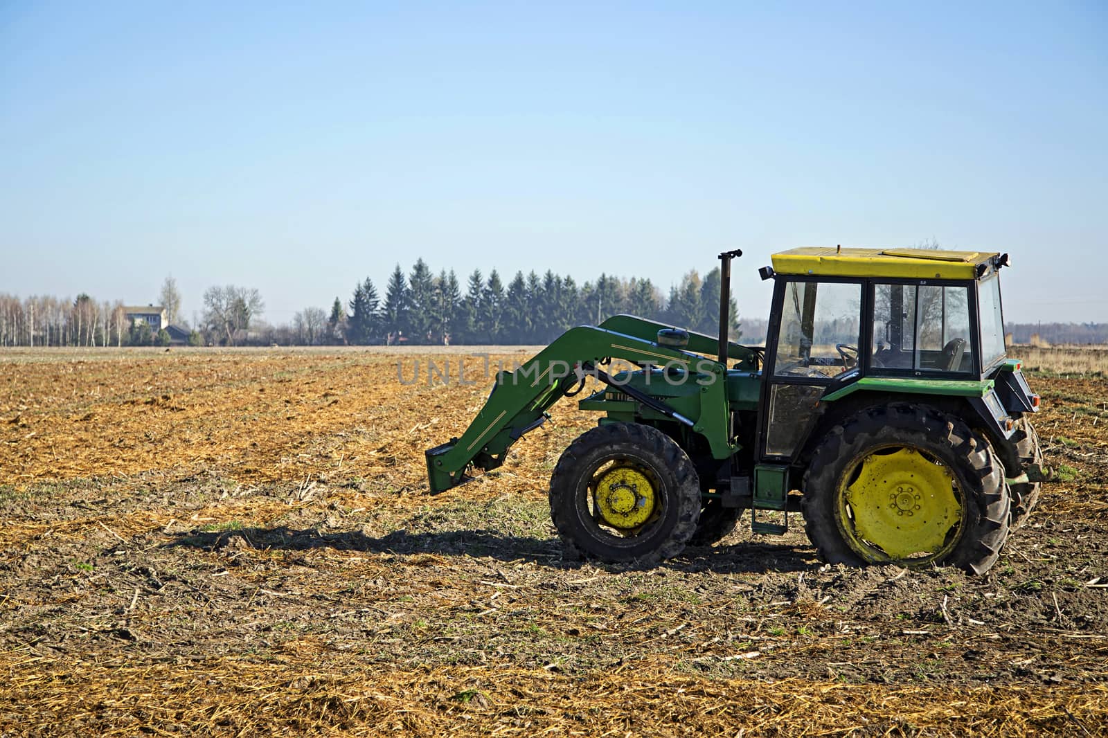 The old green tractor in a field