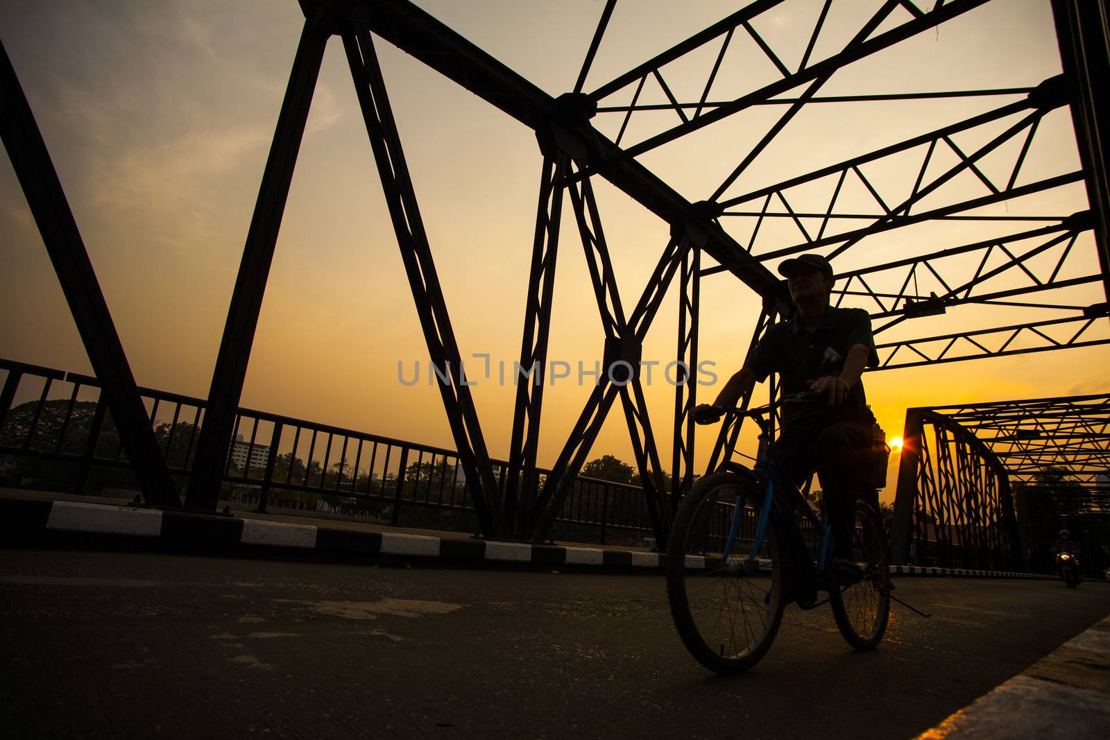Man ride bicycle silhouette on bridge by 2nix