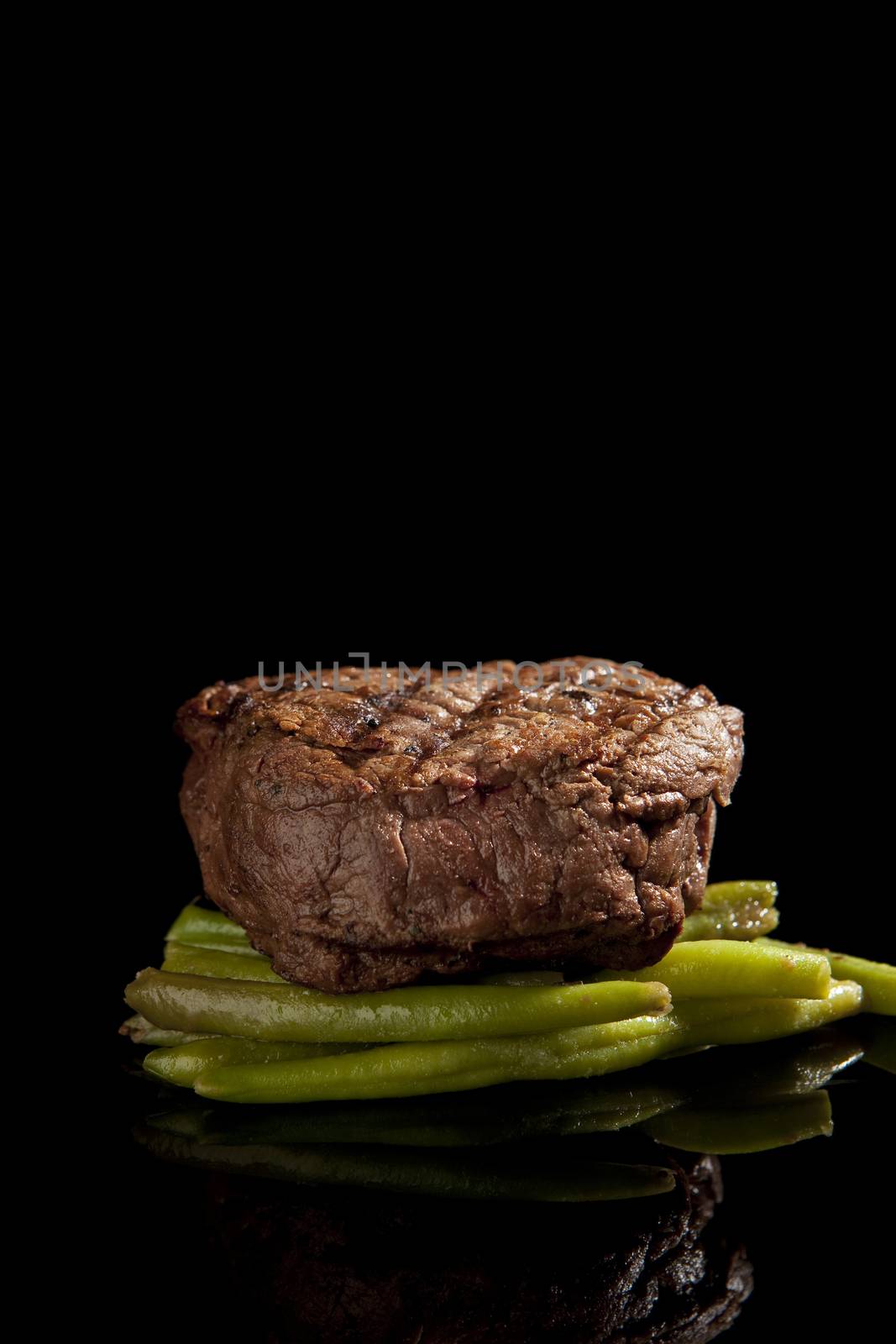 delicious beef steak on black background