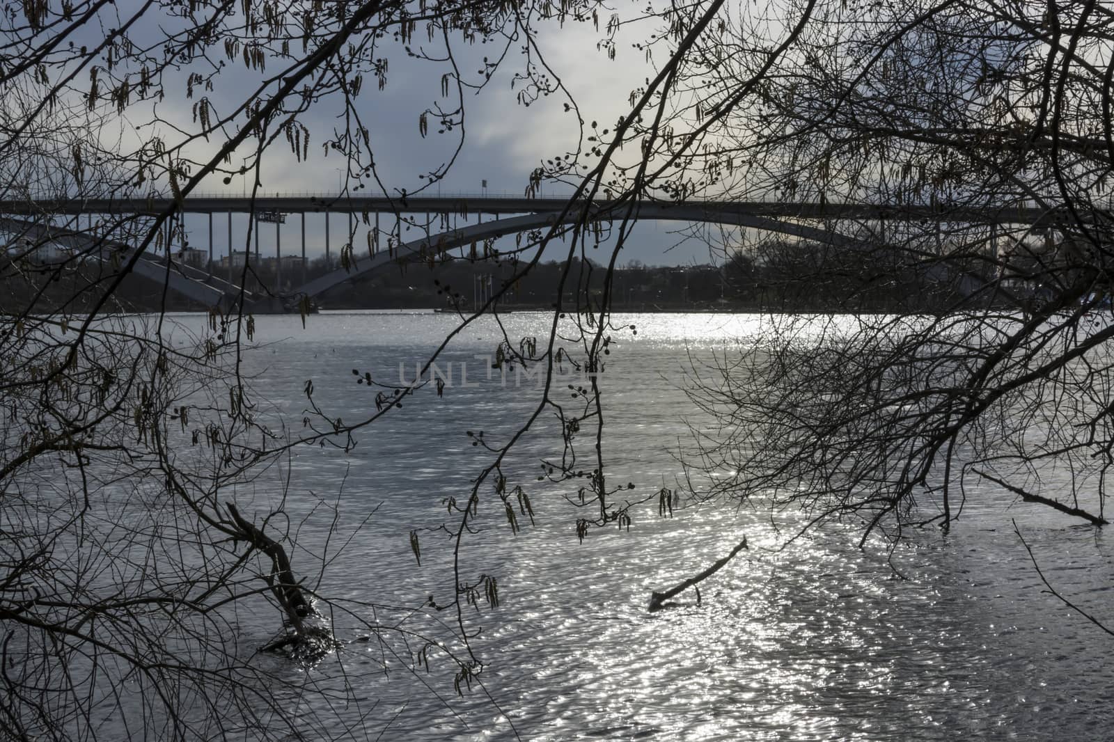 Stockholm bridge. Vasterbron in spring light, with water and trees in March, Stockholm, Sweden.