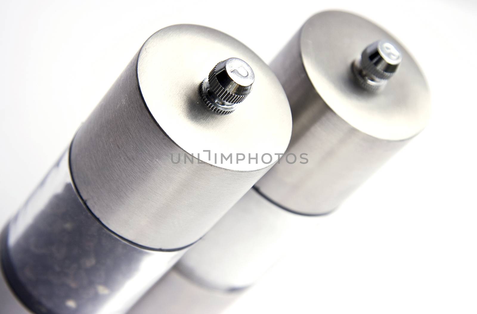 Salt and pepper mills on white background