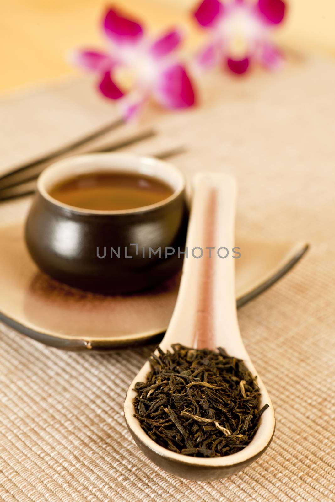 Tea leaves on a tea spoon by eskymaks