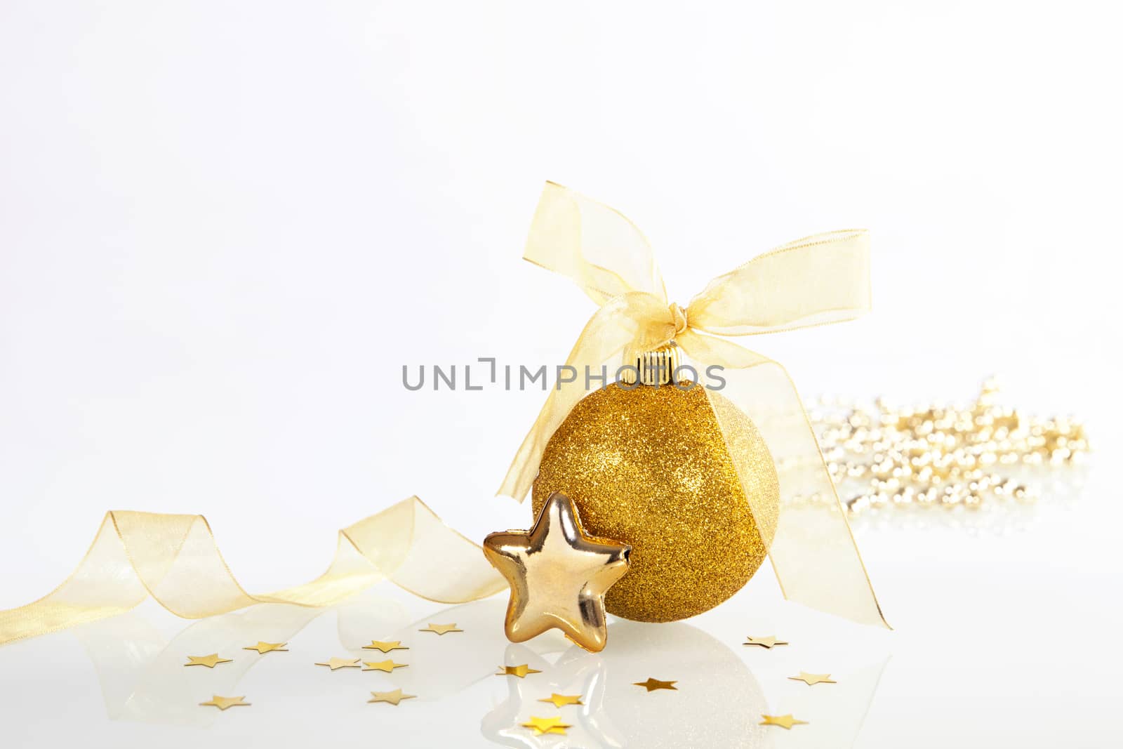 Golden shiny christmas decoration on white background.
