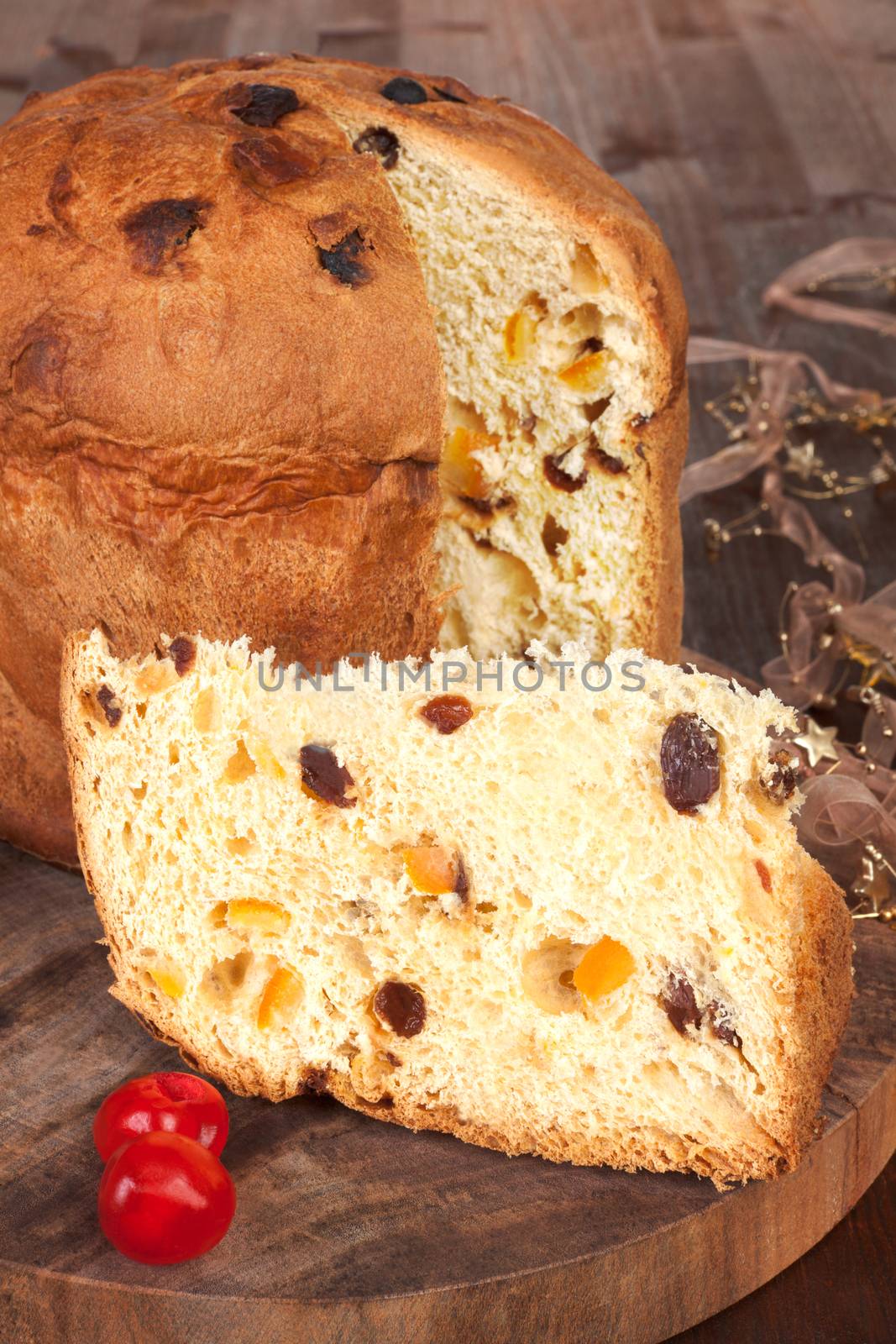 Traditional italian panettone fruit cake on brown wooden background. Culinary 