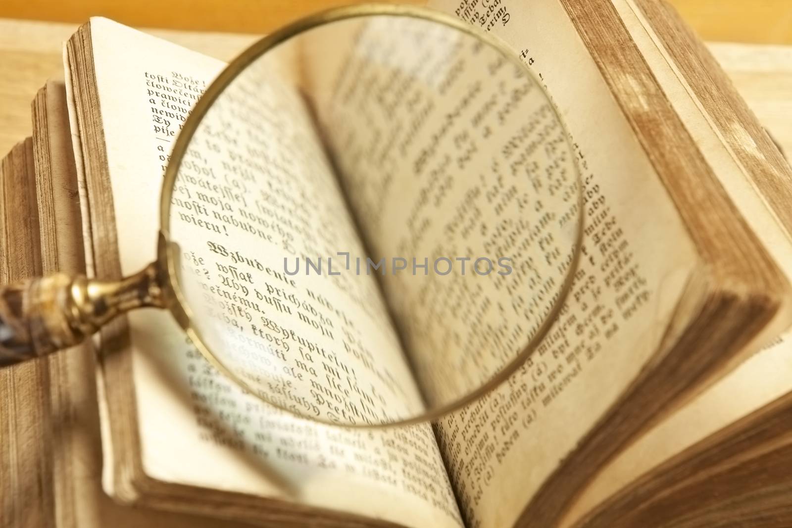 Old antique open book with antique magnifier. Knowledge concept. Learning background.