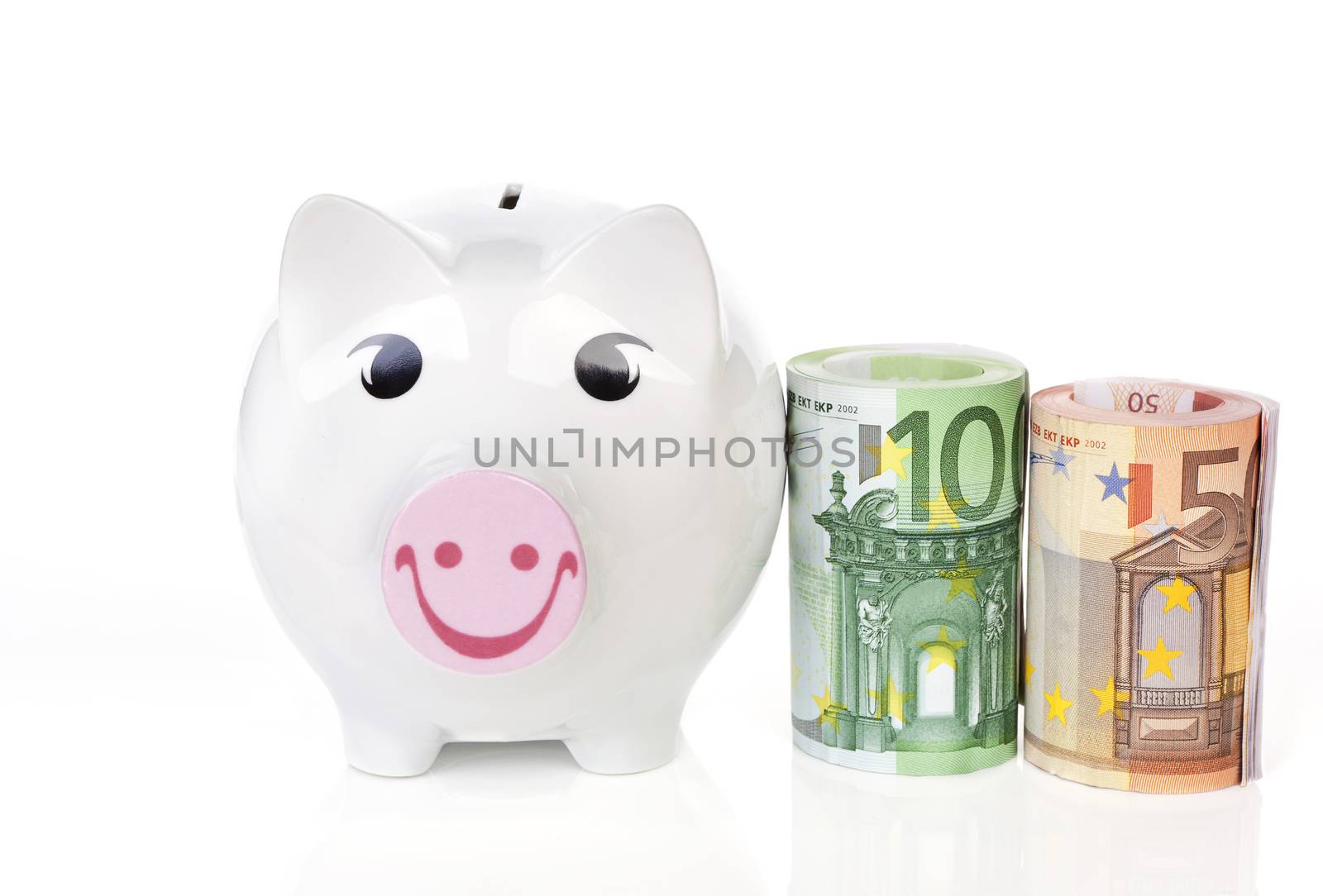 Happy piggy bank with hundred and fifty eur notes bundle next to it isolated on white background. Saving concept.