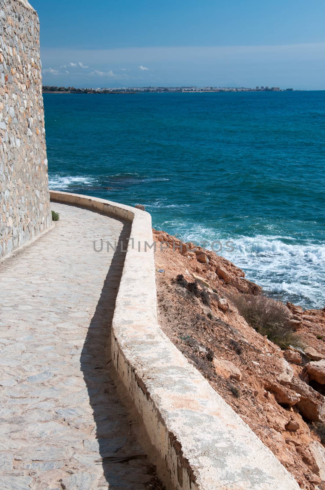Edgy path along Mediterranean shore with horizon, La Zenia, Costa Blanca, Spain.