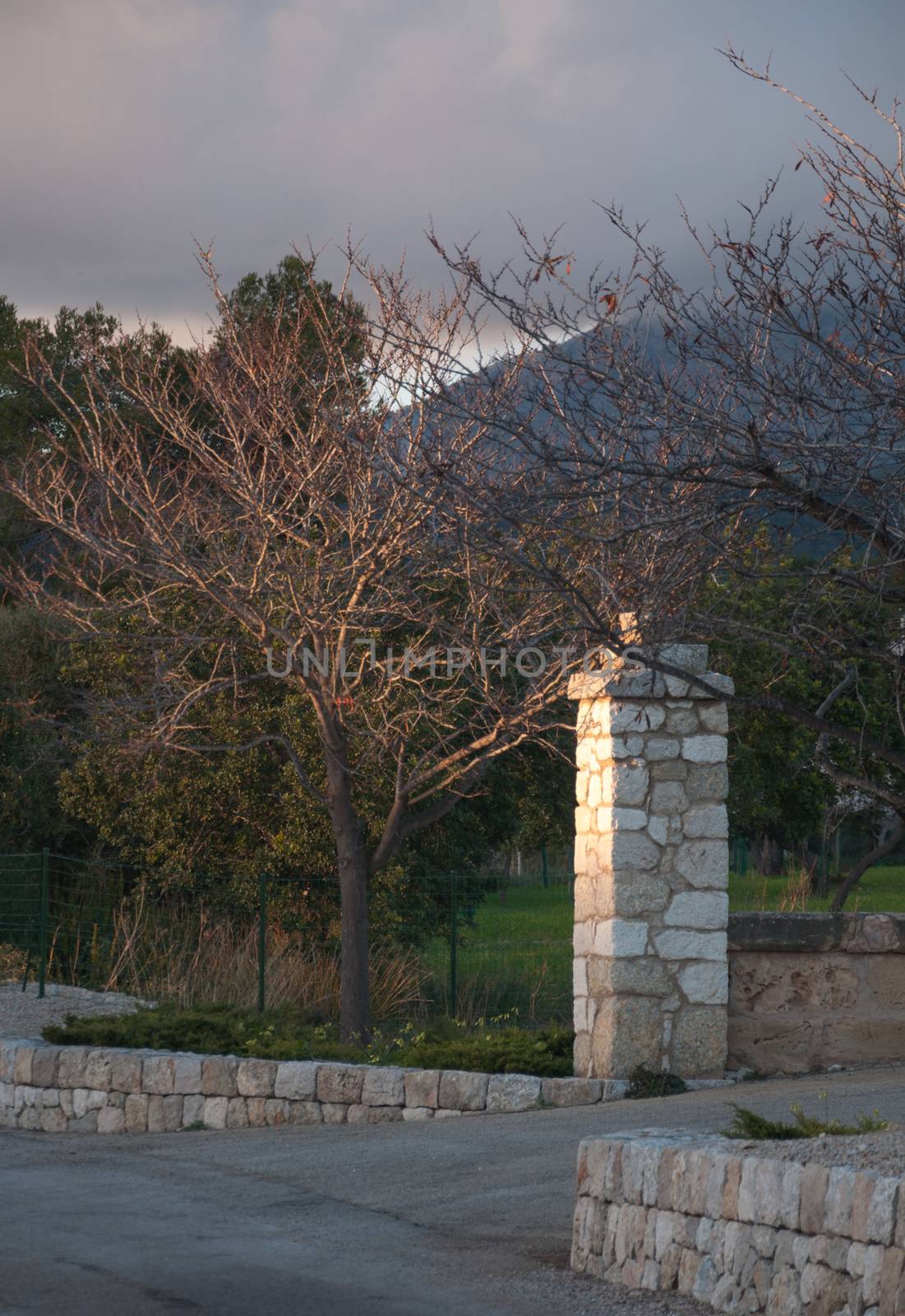Entrance with stone post in rural Mallorca. Majorca, Balearic islands, Spain.