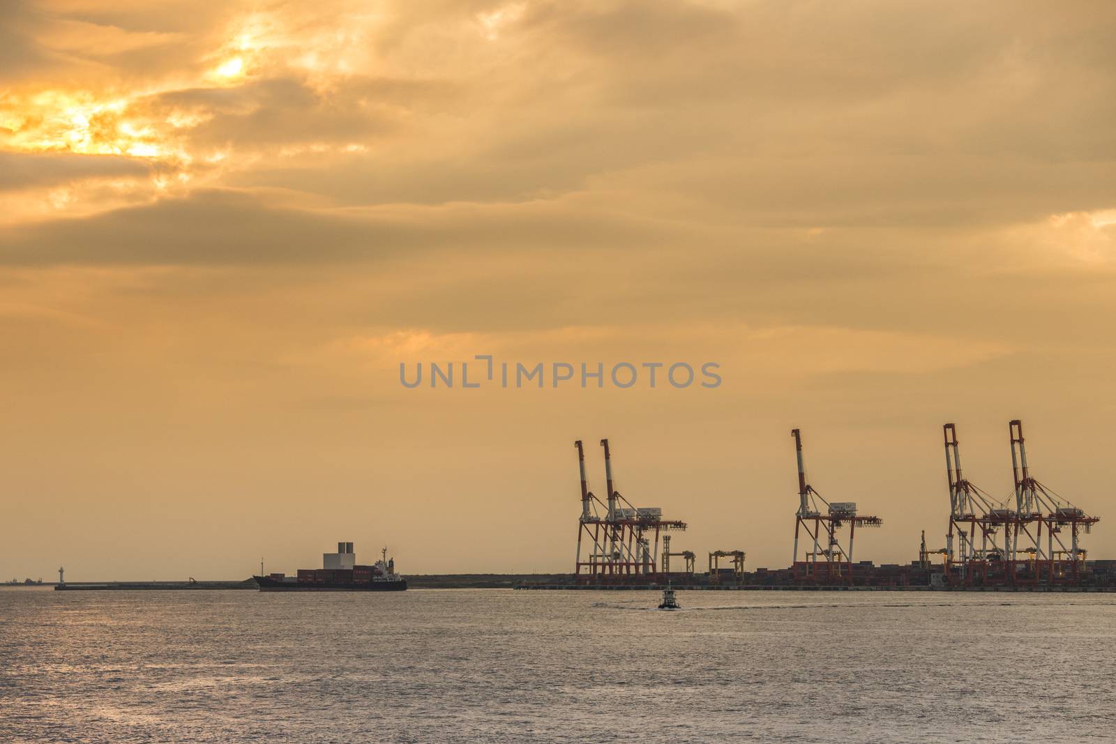 Container stacks and crane in shipyard at sunset for cargo Goods and Logistic background