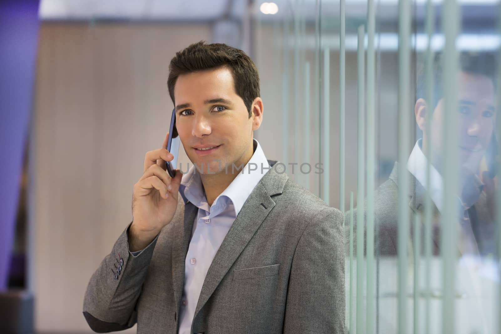 Male smiling mobile phone business looking camera office