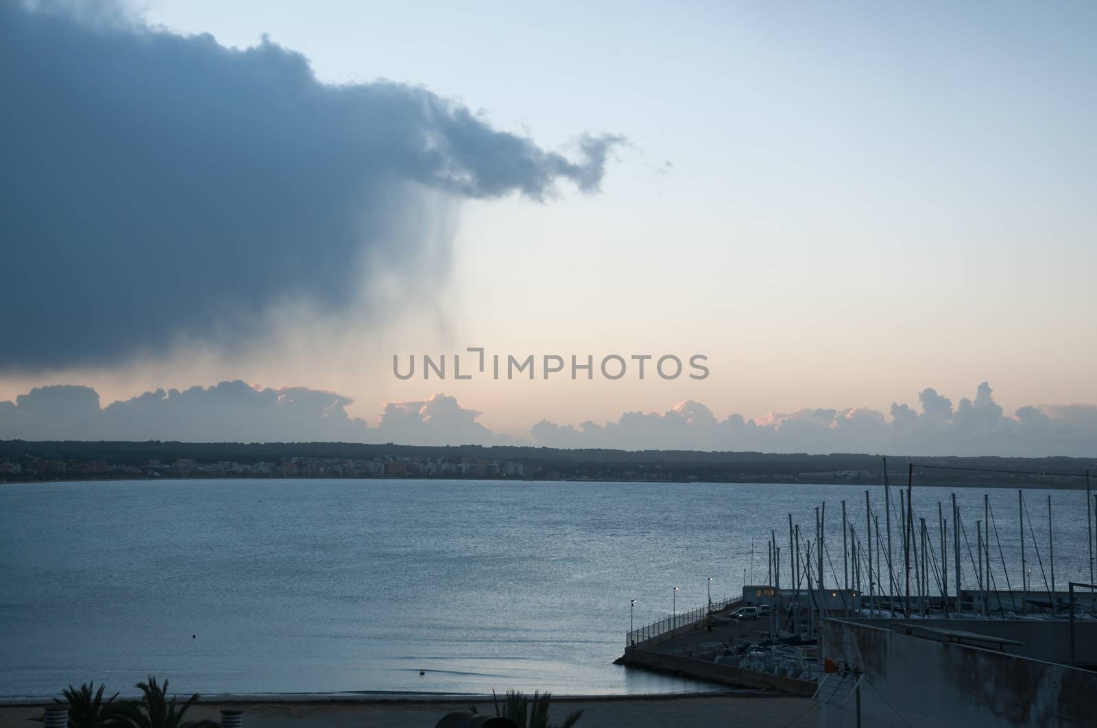 Cloud with rain sweeping out to sea in a winter morning in February, Can Pastilla, Majorca, Spain.