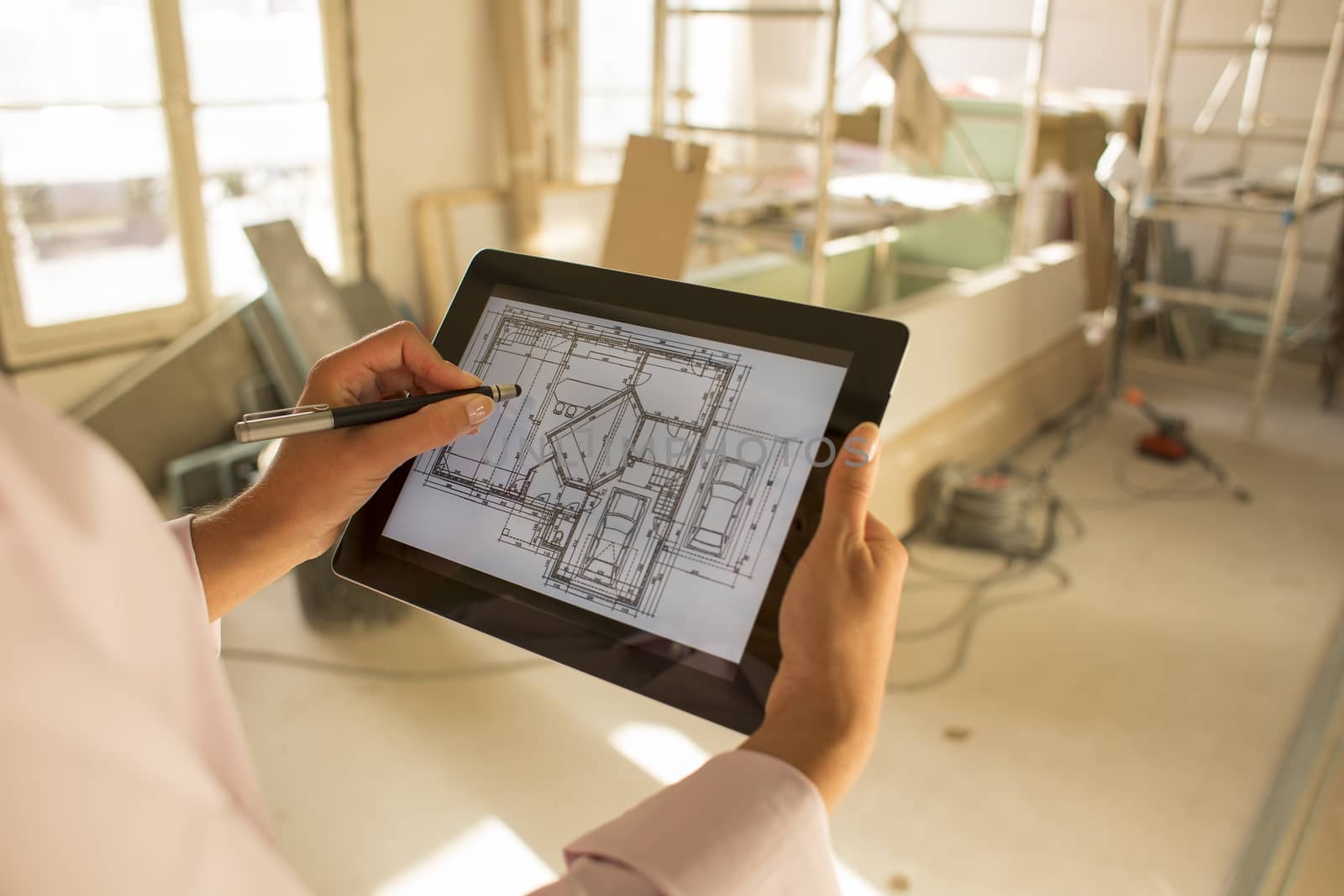 Architect woman working with electronic tablet by LDProd