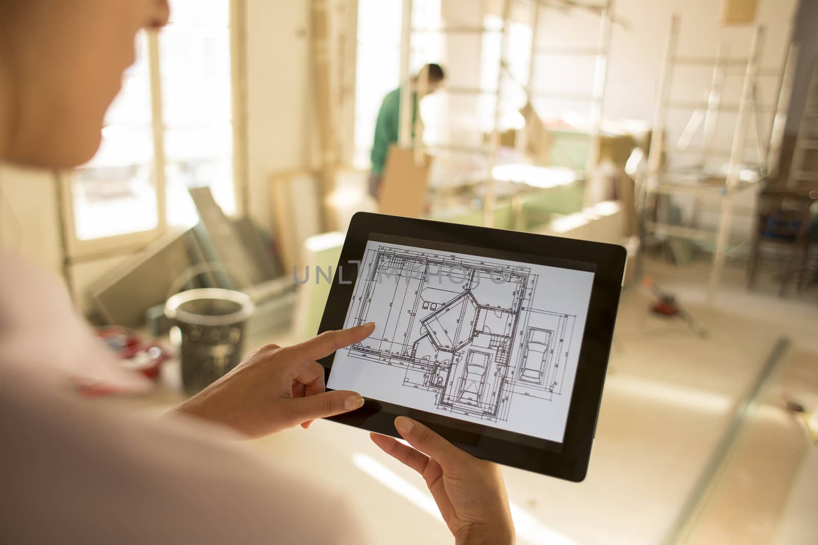 Architect woman working with electronic tablet by LDProd