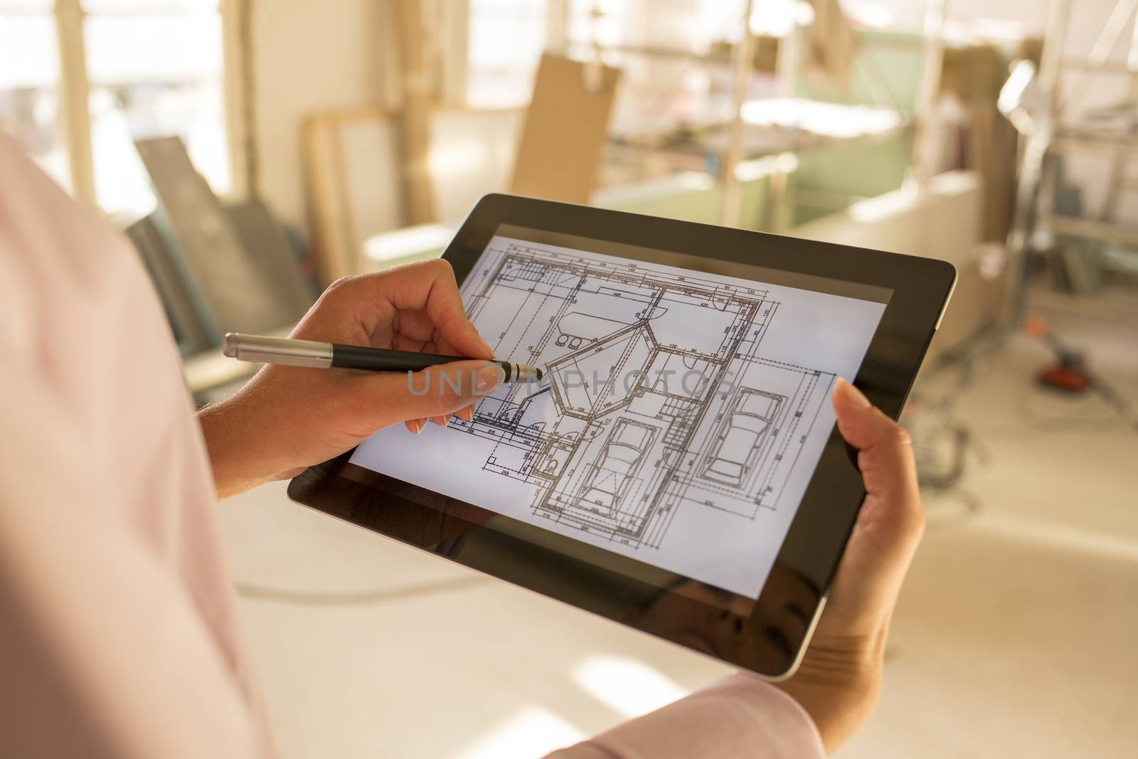 Architect woman working with electronic tablet by LDProd