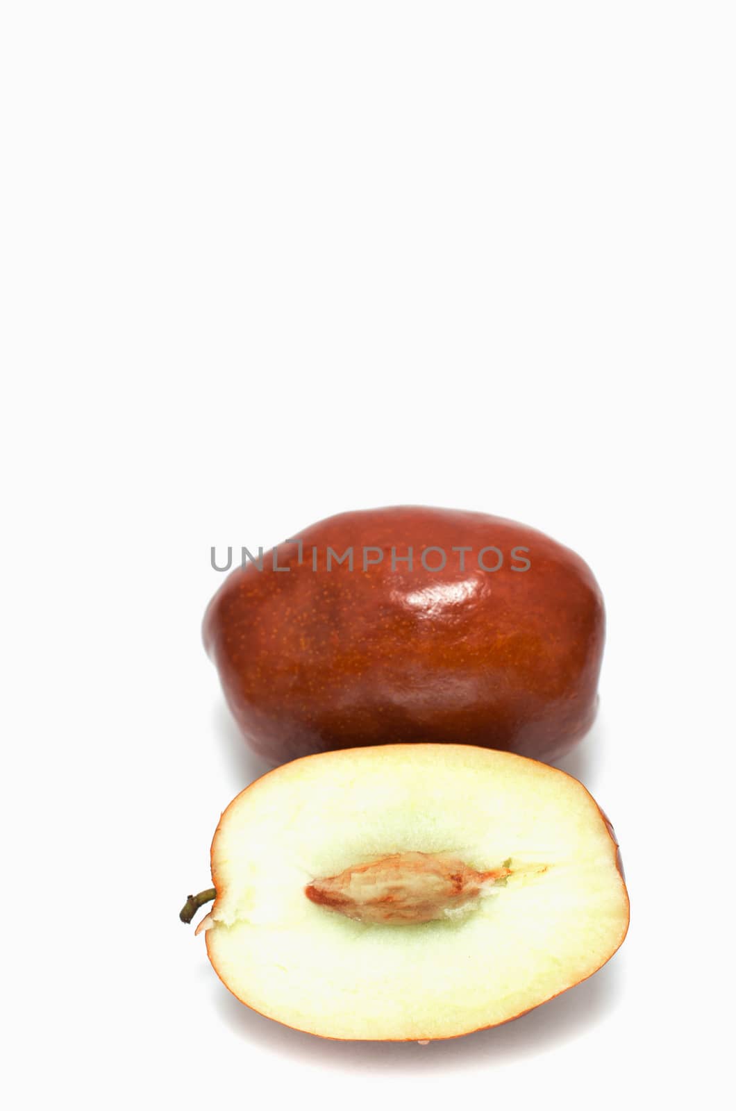 Whole and sliced unabi berries isolated on the white background 