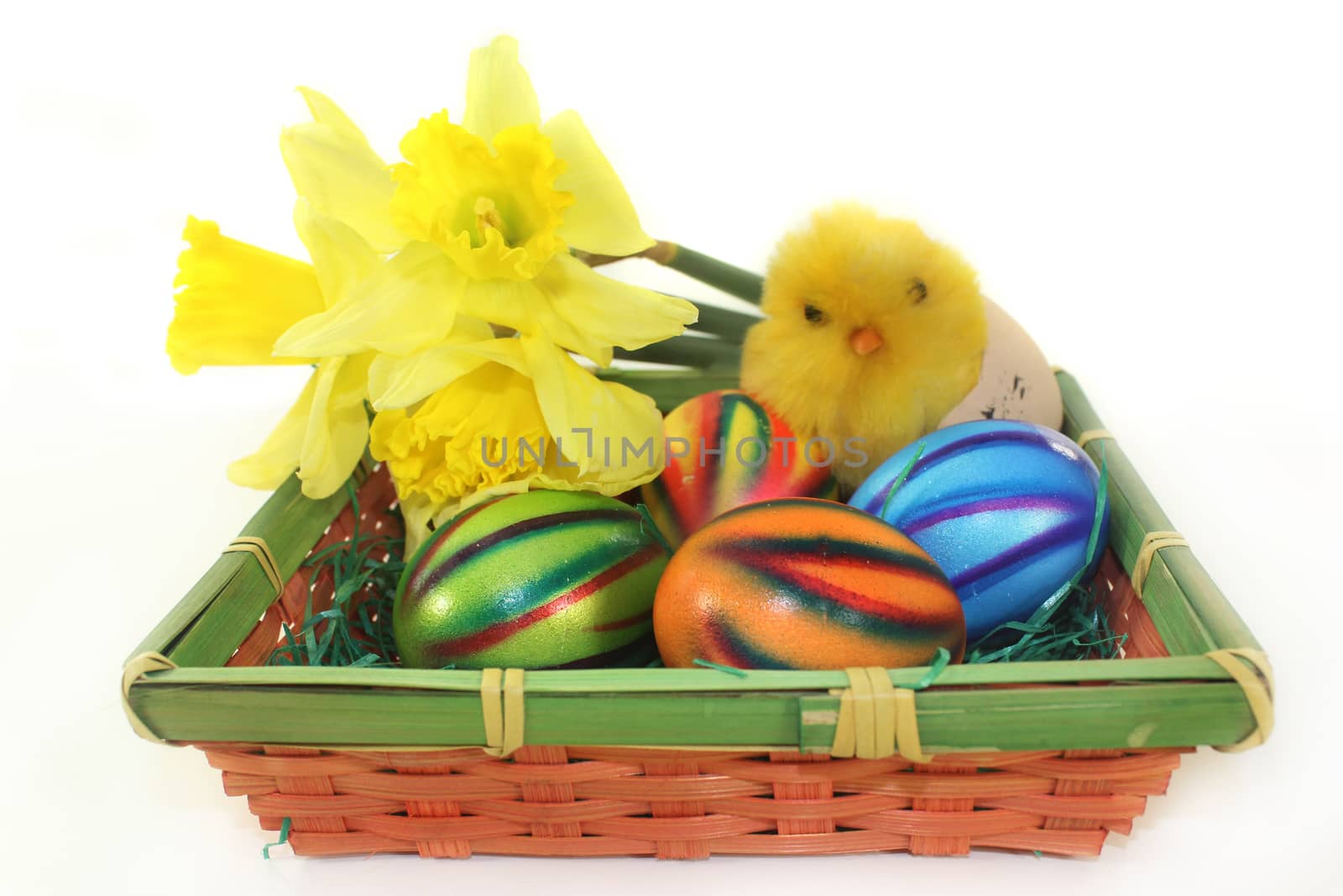 an Easter basket of colorful easter eggs and daffodils