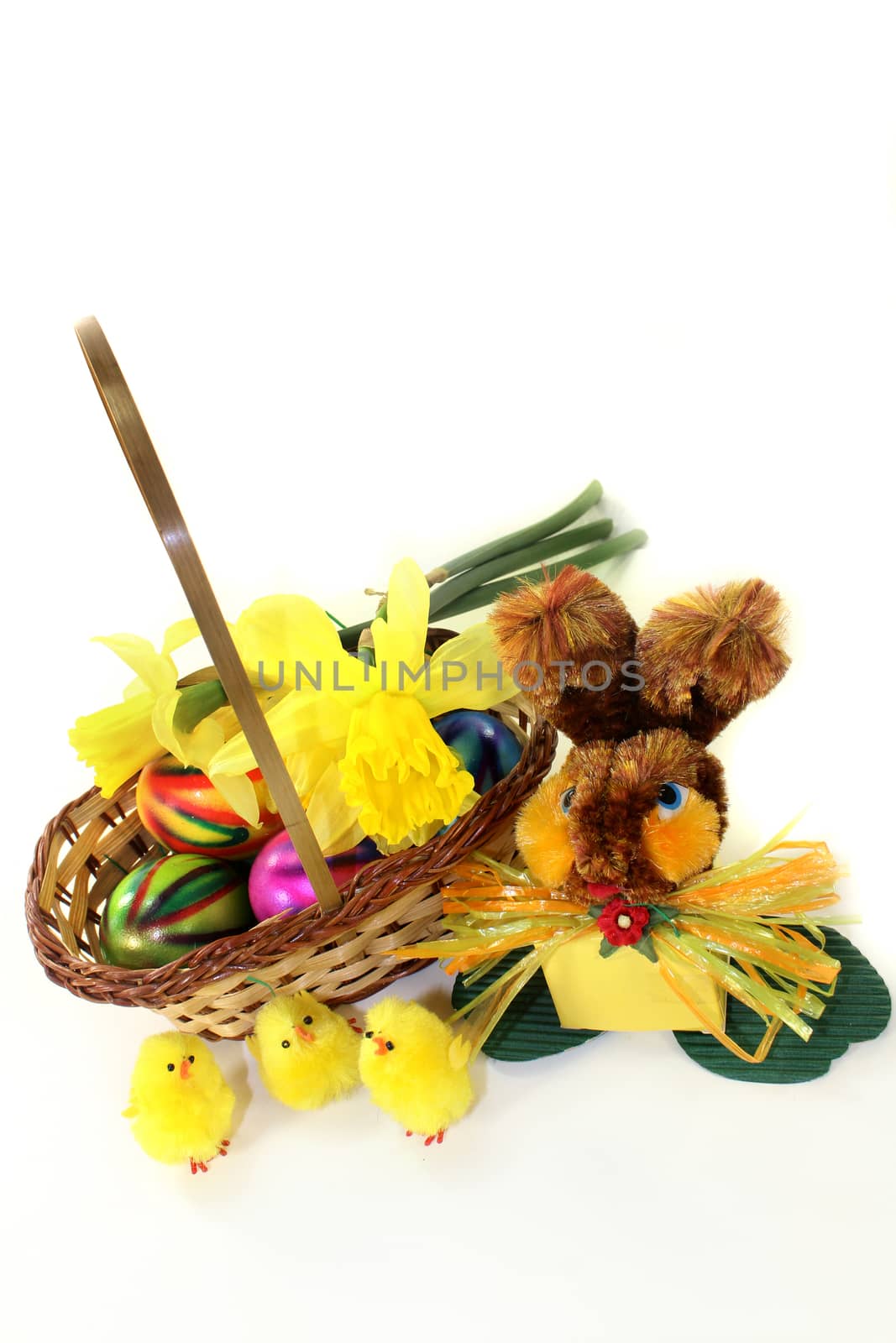 an Easter basket of colorful easter eggs and daffodils