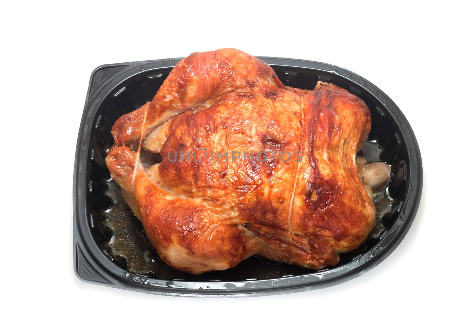 Roasted chicken in a commercial plastic container