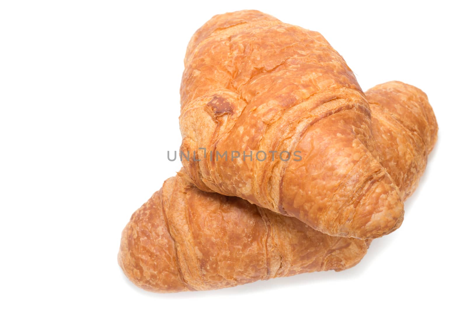 Two French croissants on white background