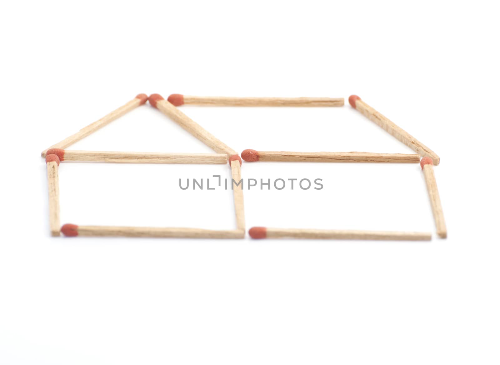 The abstract house made matches, isolated on white background