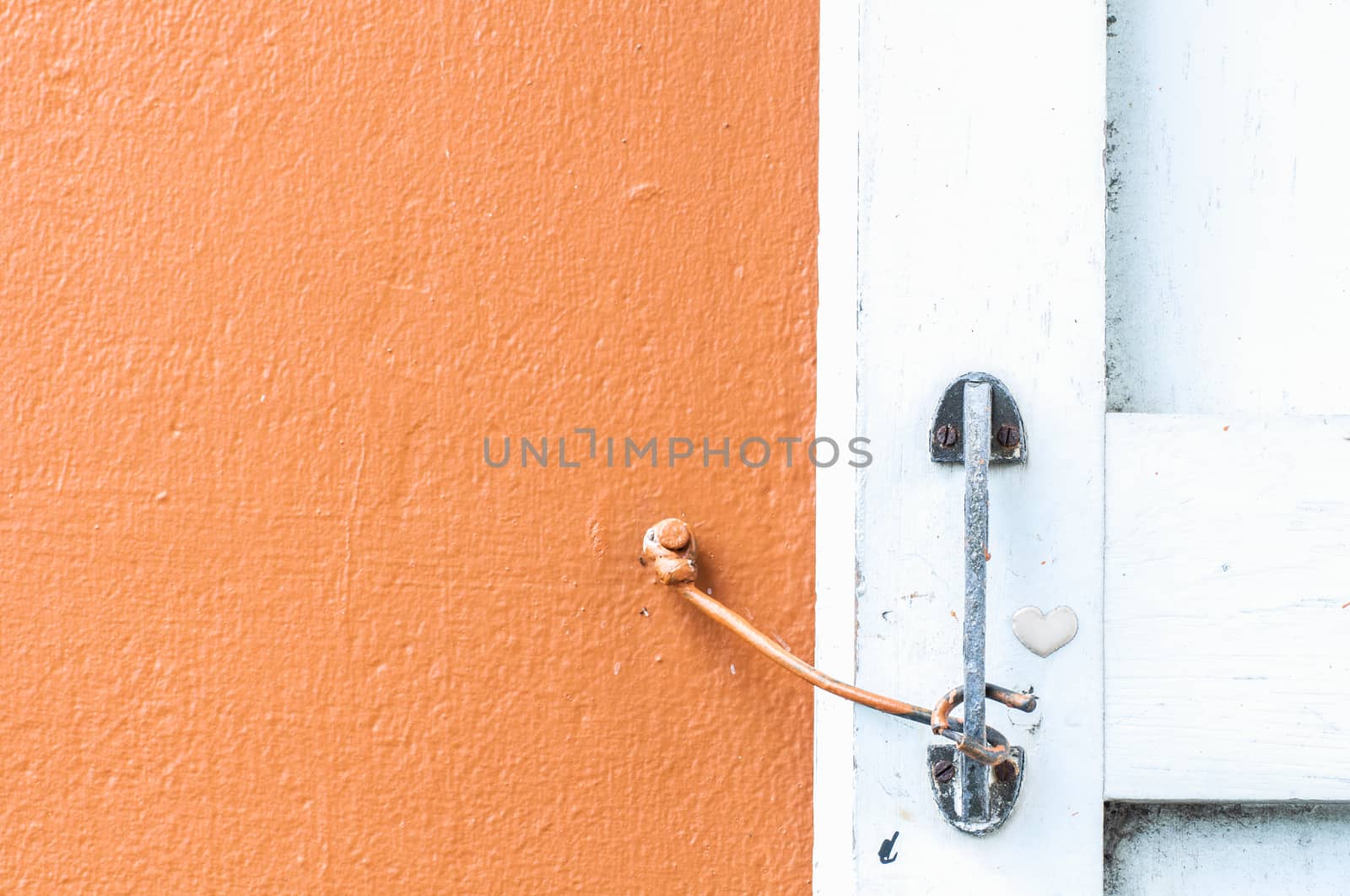 orange wall with a windows and hook