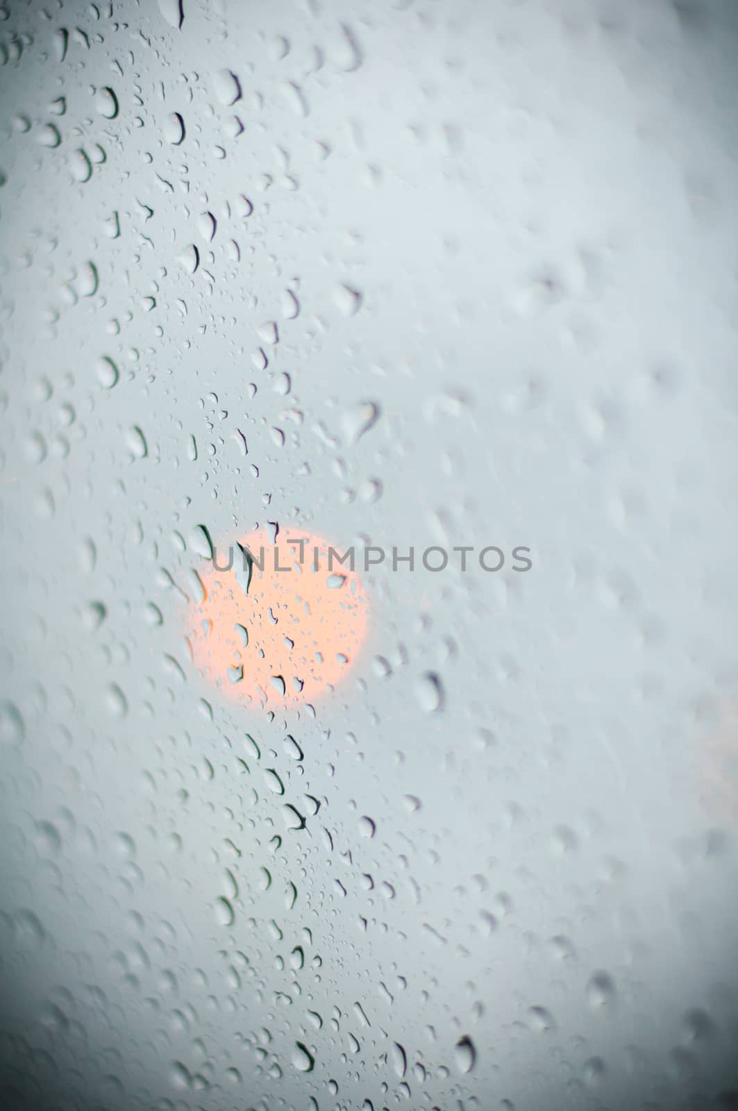 water drop on glass and the lights in the background.