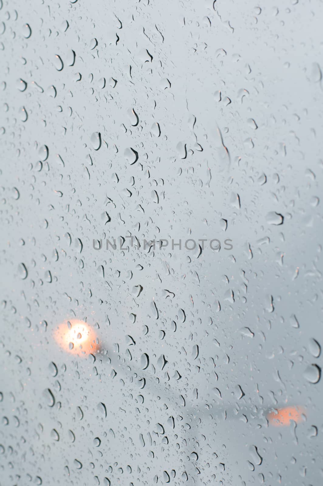 water drop on glass and the lights in the background.