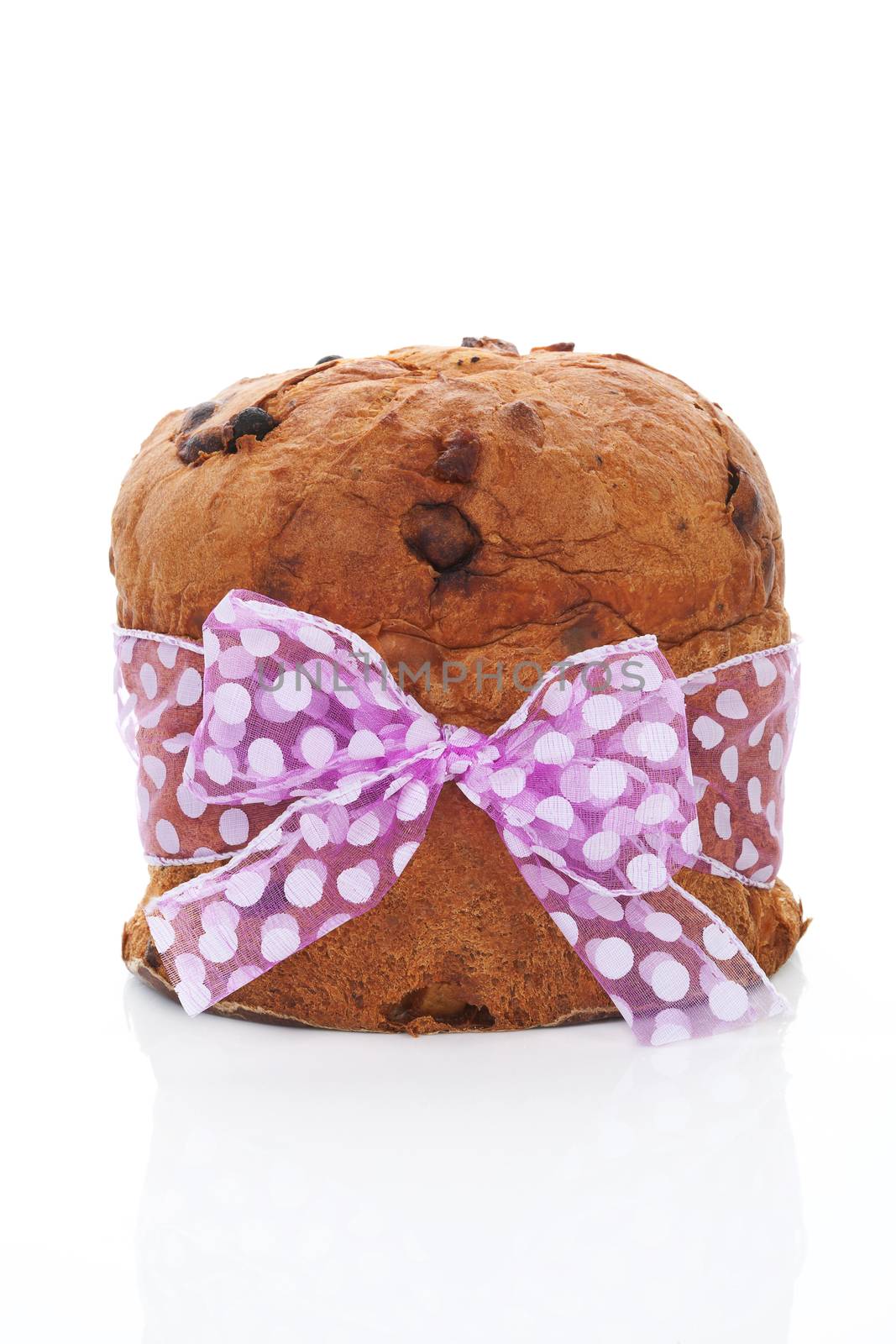 Delicious luxurious panettone fruit cake with purple bow isolated on white background. Culinary sweet dessert.